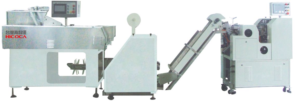 A white machine with a conveyor belt attached to it.