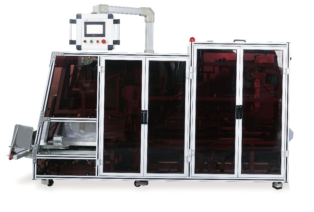 A machine with a monitor on top of it is sitting on a white surface.