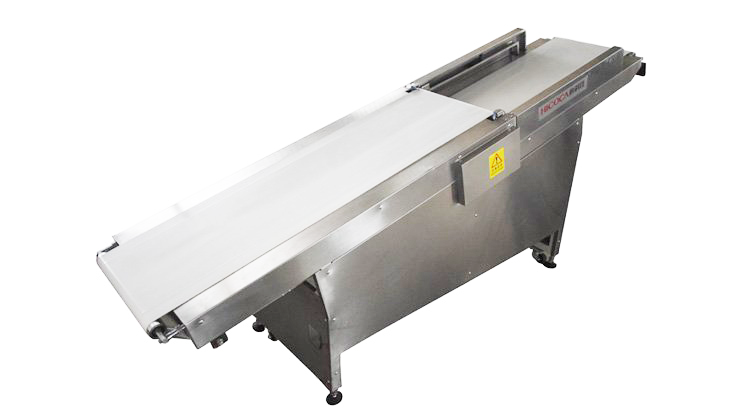 A stainless steel conveyor belt is sitting on a white surface.