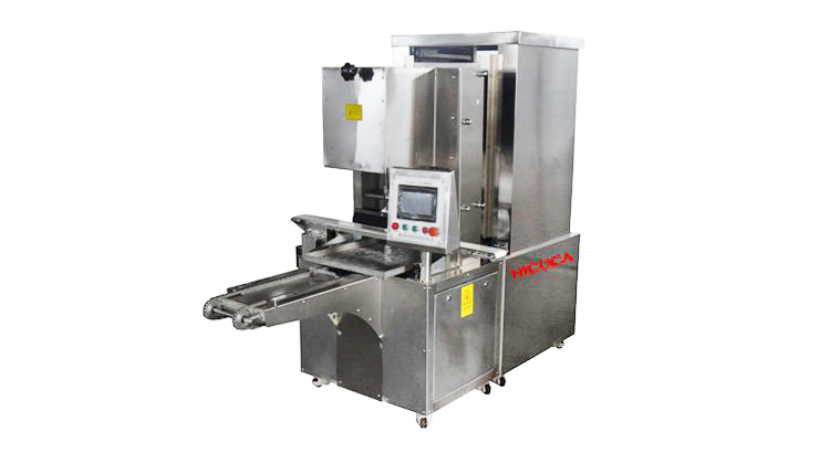 A stainless steel machine is sitting on a white surface.