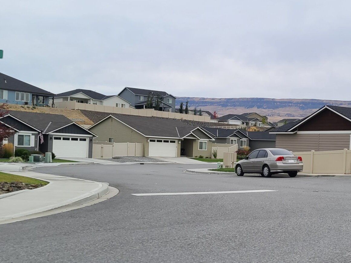 A car is parked on the side of the road in a residential area