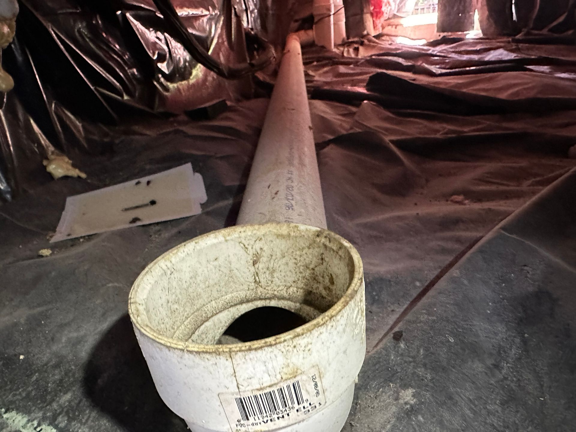 A white pipe with a hole in the middle of it
