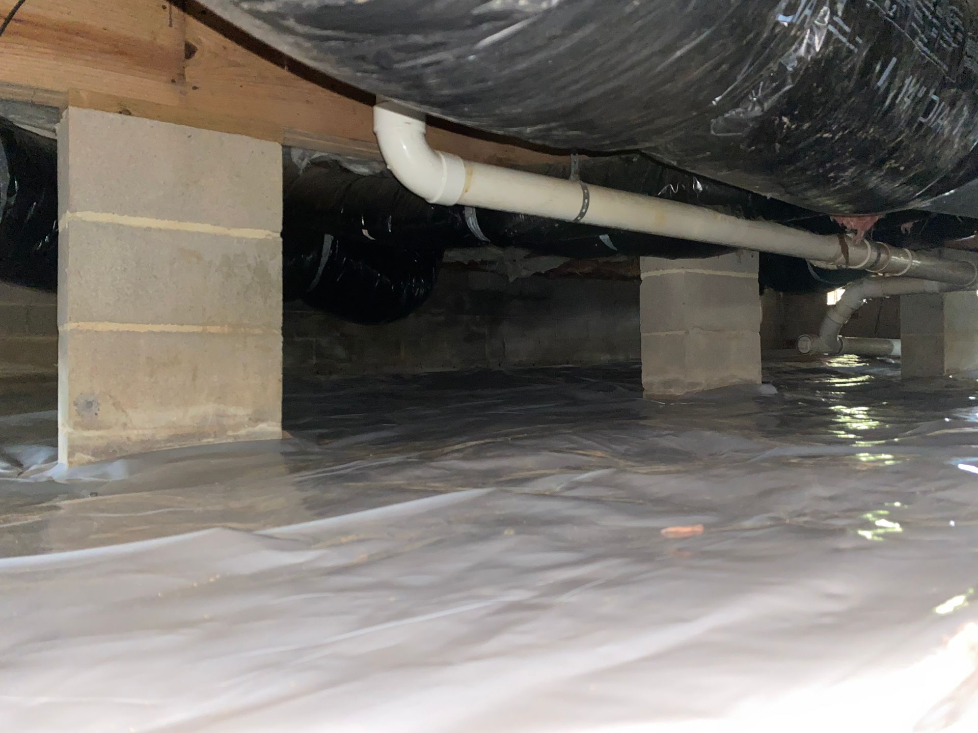 A basement with a lot of pipes coming out of it.