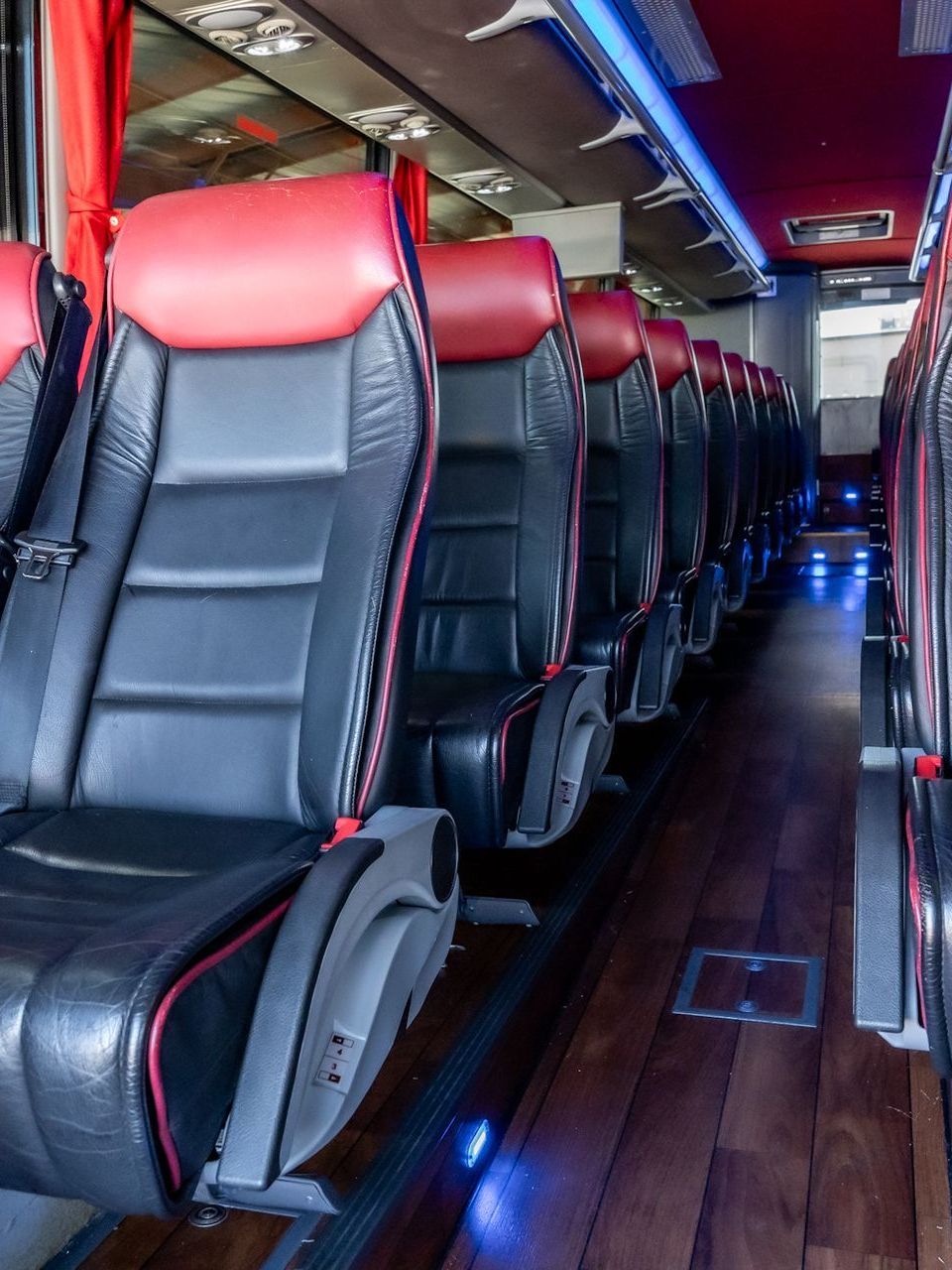 The inside of a bus with red and black seats. executive coaches premium chauffeur service memphis  tn