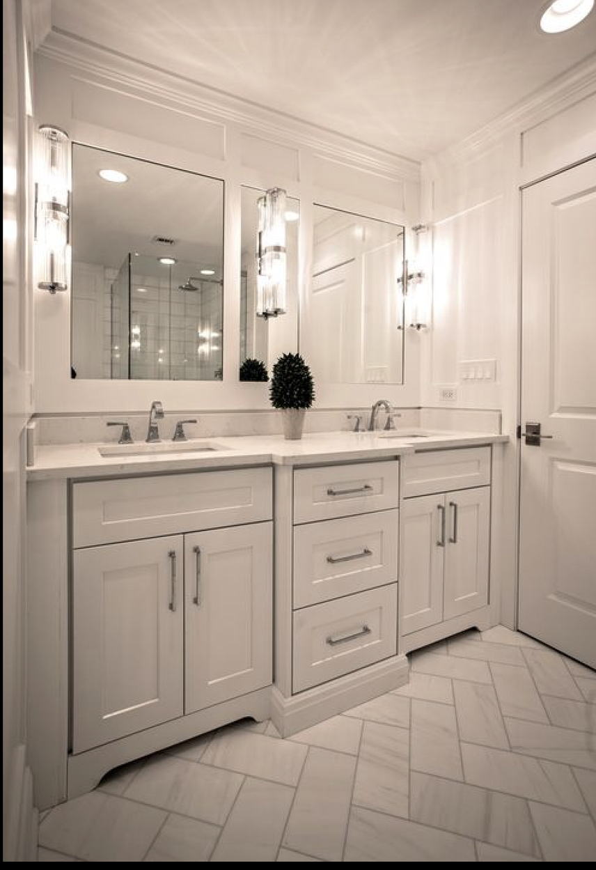 A bathroom with two sinks and two mirrors