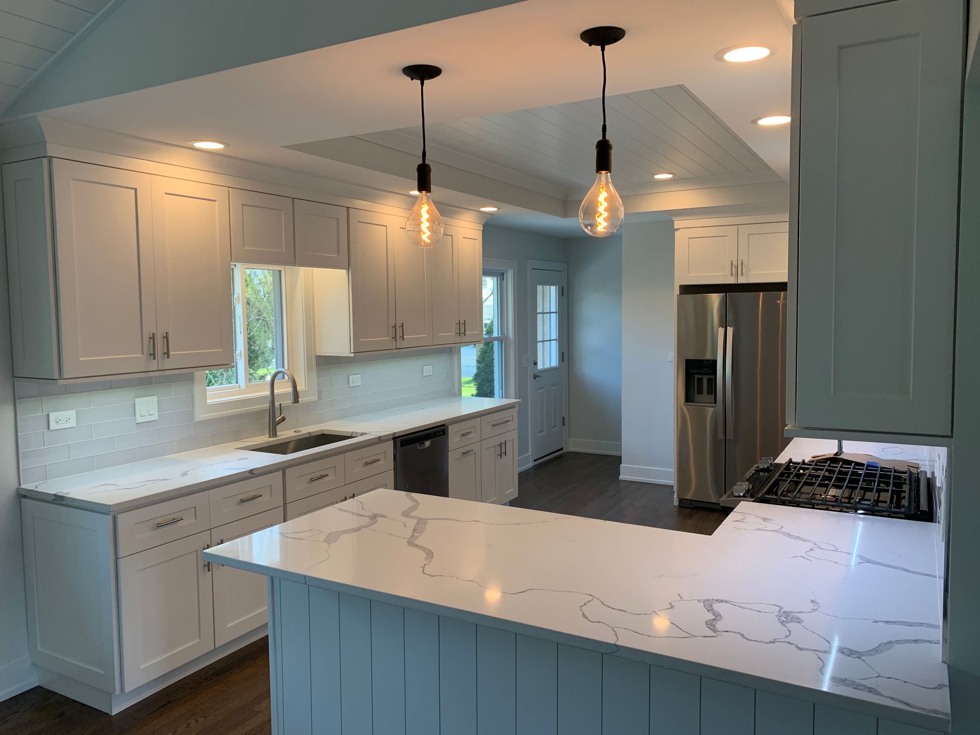 A kitchen with white cabinets and stainless steel appliances.