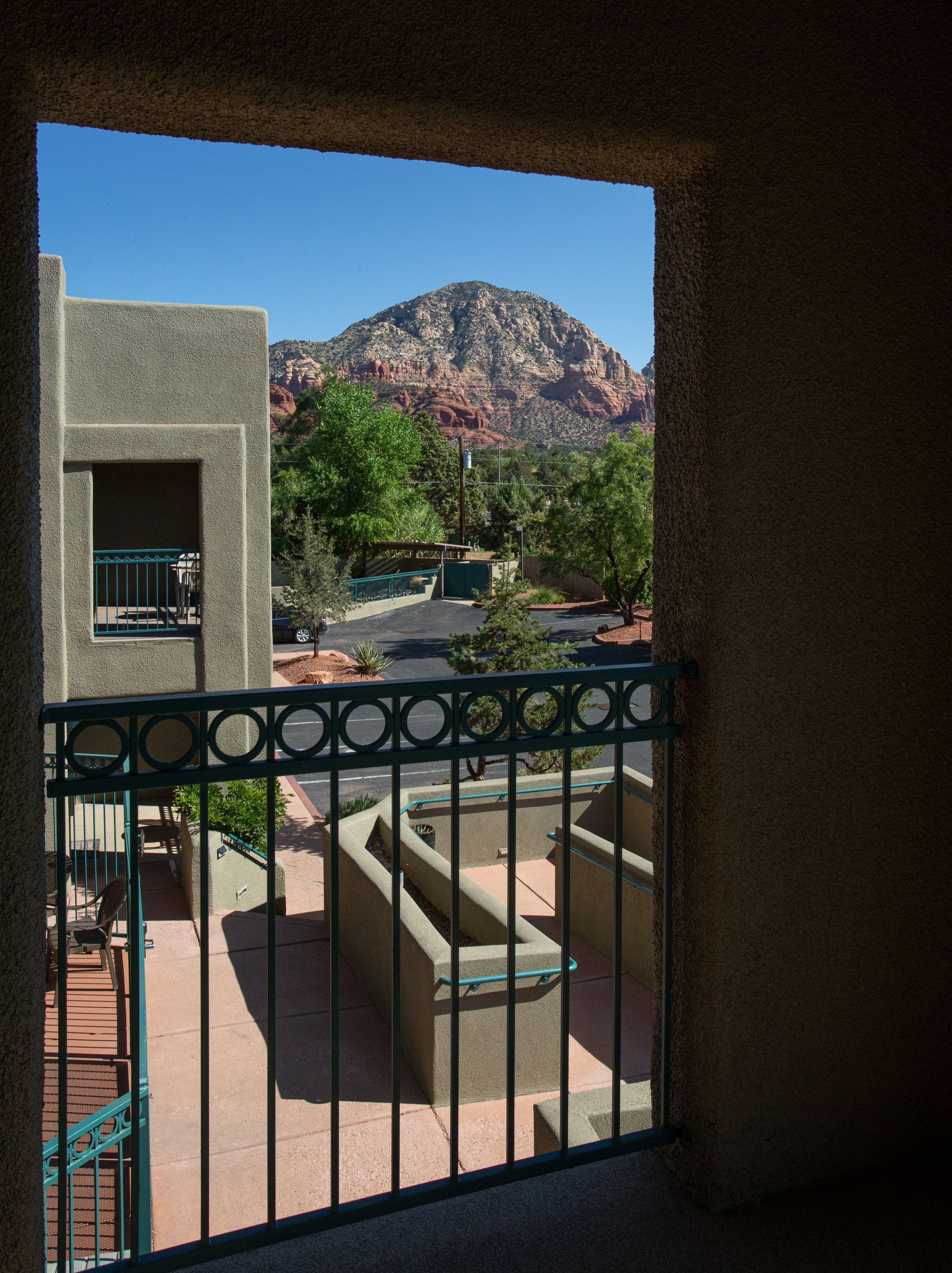 A balcony with a view of mountains and trees