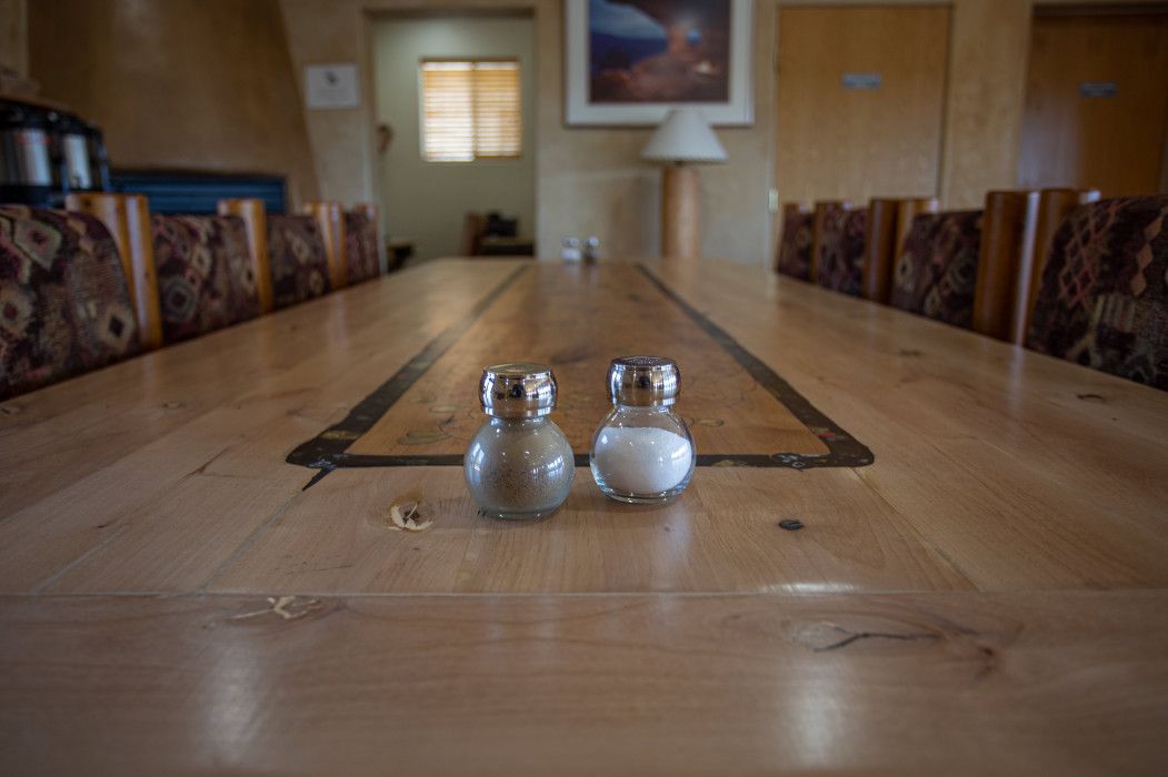 Two salt and pepper shakers on a wooden table at Southwest Inn Sedona
