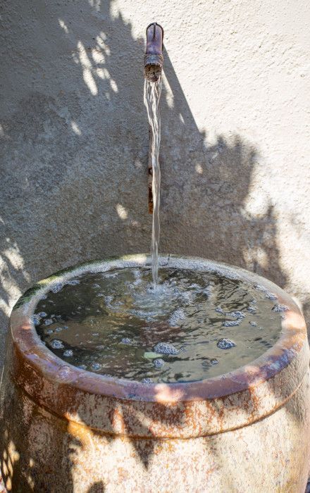 Close-up of a fountain with water flowing from a faucet at Southwest Inn Sedona