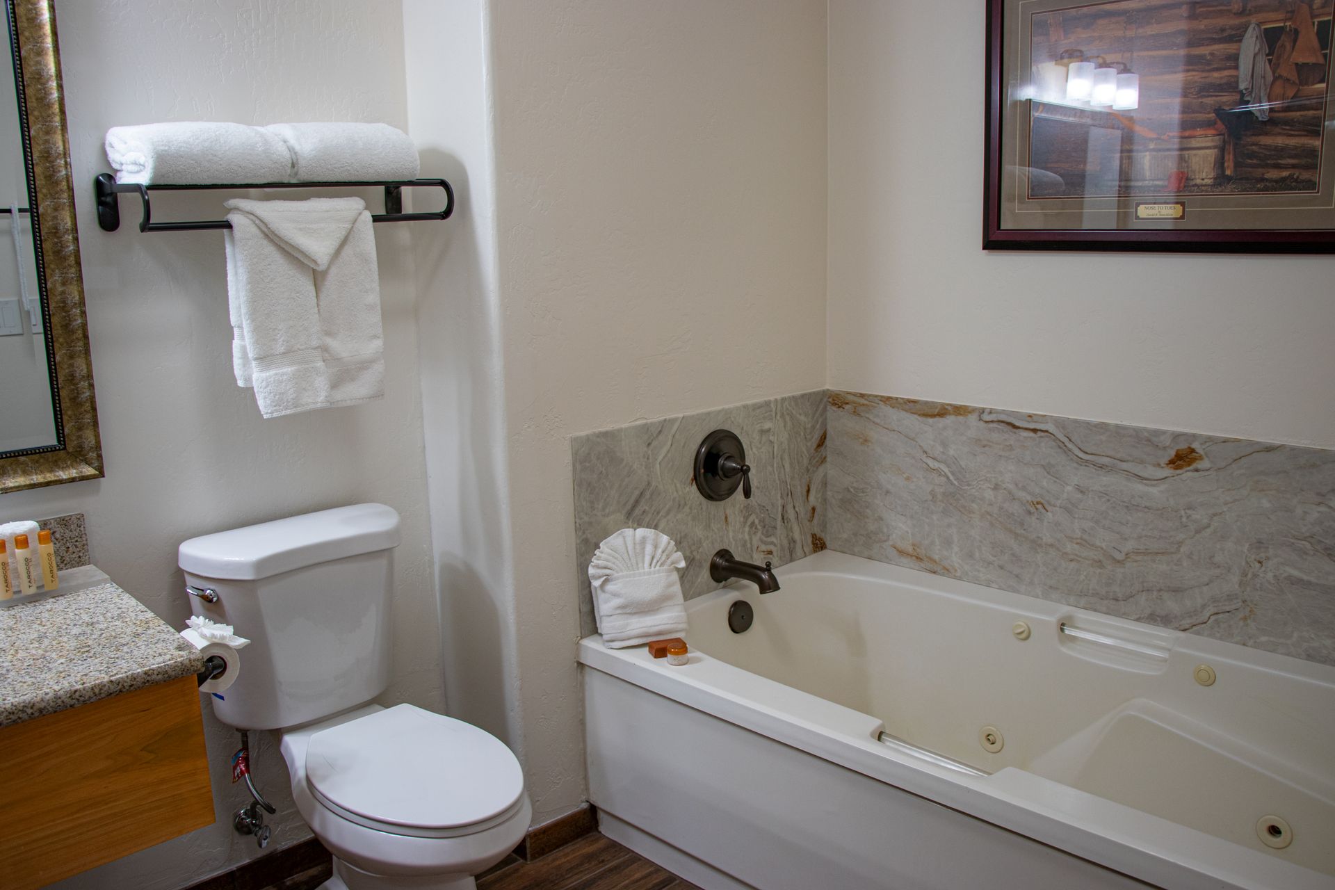A bathroom with a toilet , sink , and bathtub.