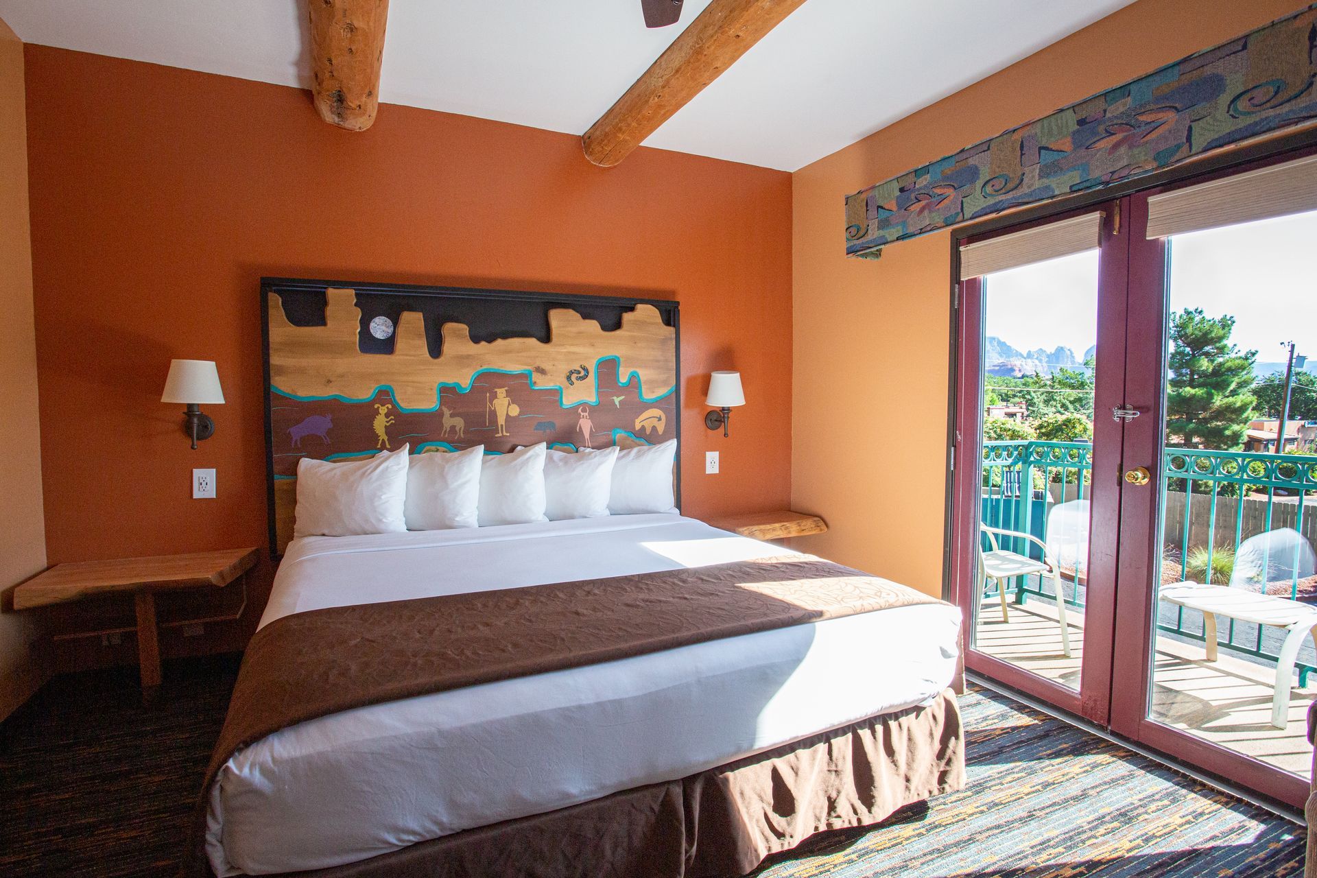 A hotel room with a king size bed and a balcony