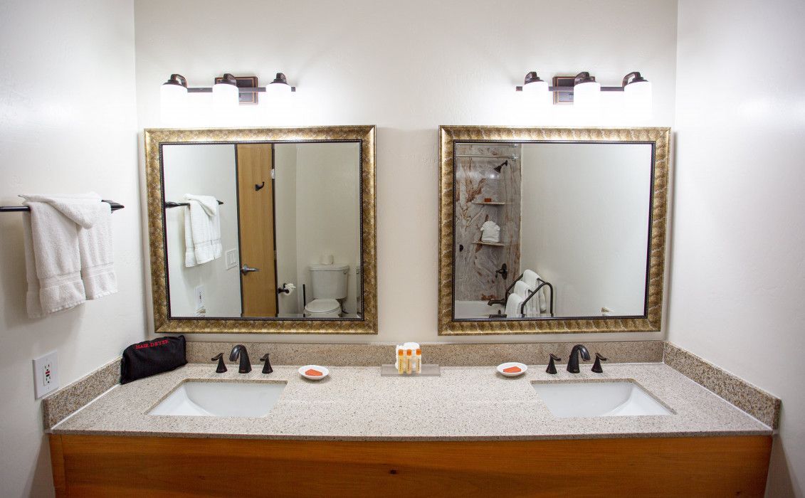 Spacious bathroom at Southwest Inn Sedona with double sinks and dual mirrors