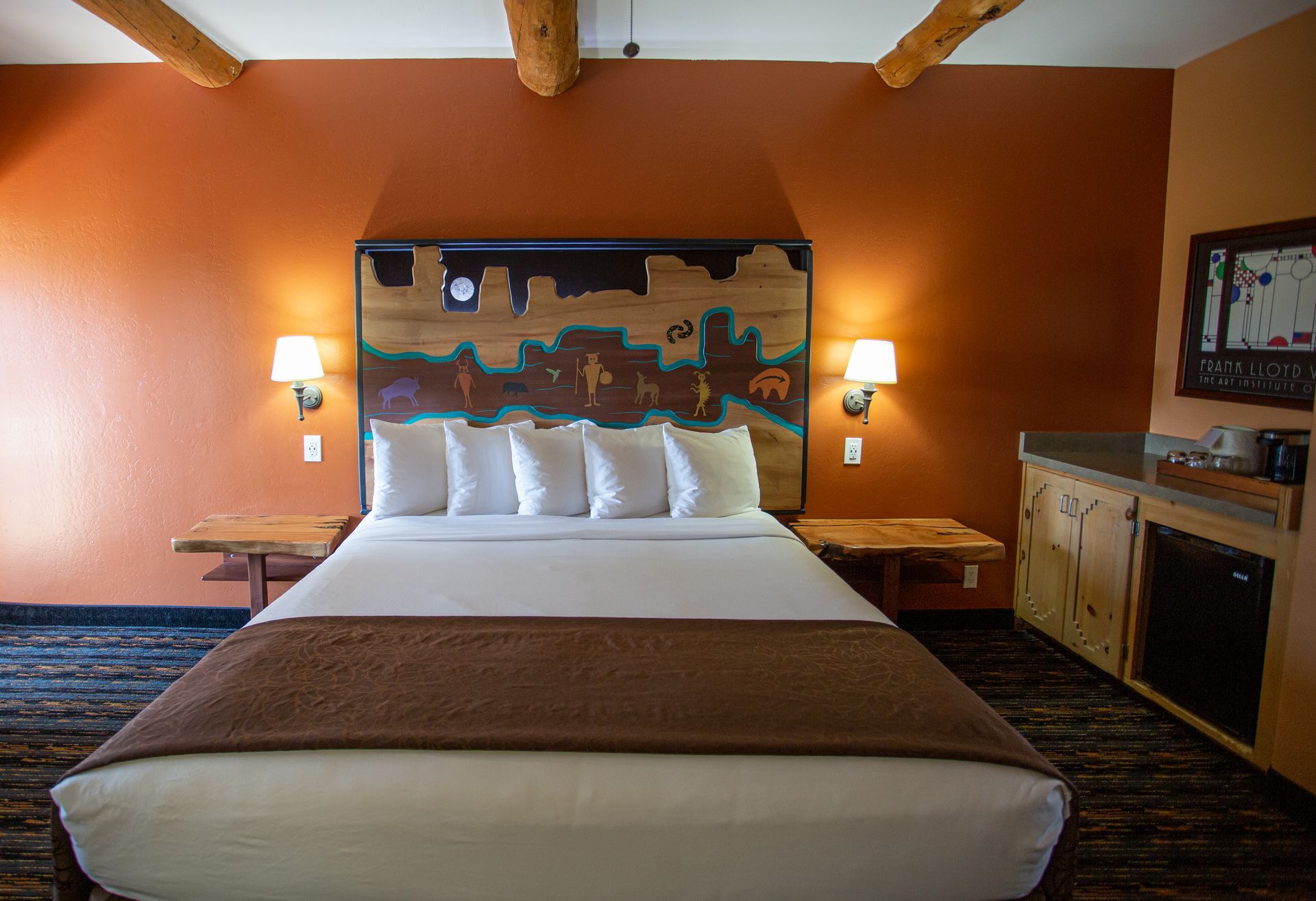 A hotel room with a king size bed and a flat screen tv.