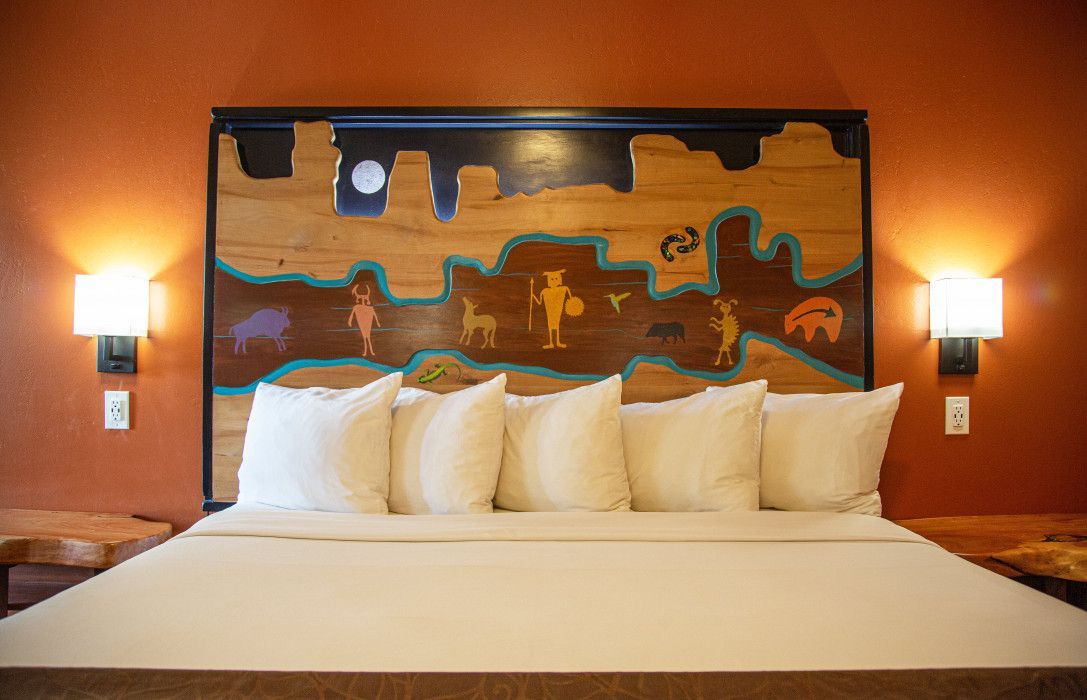 Hotel room at Southwest Inn Sedona with a king-size bed and rustic wooden headboard