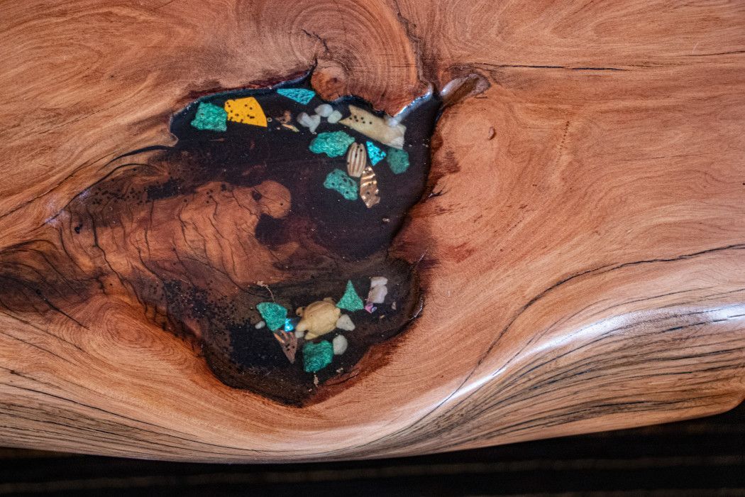 Close-up of a weathered piece of wood with a hole, highlighting rustic details at Southwest Inn Sedona
