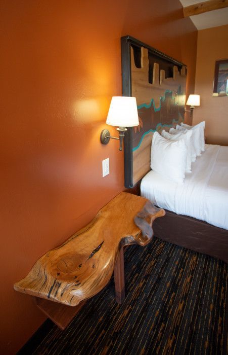 Hotel room at Southwest Inn Sedona with a comfortable bed and wooden table