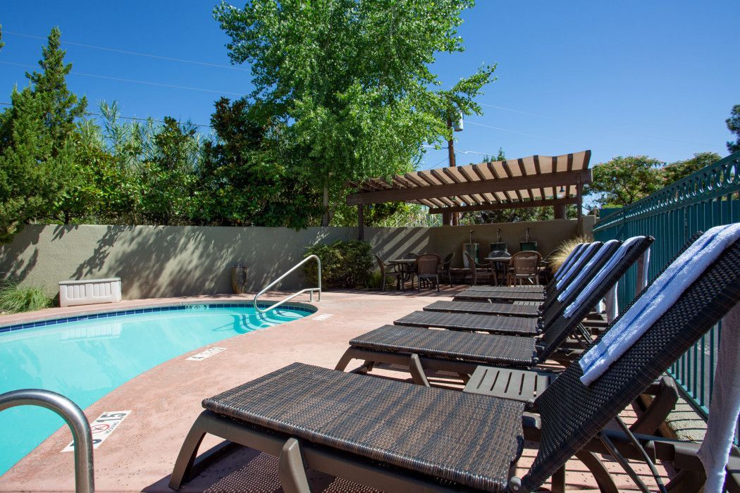Row of lounge chairs next to the swimming pool at Southwest Inn Sedona