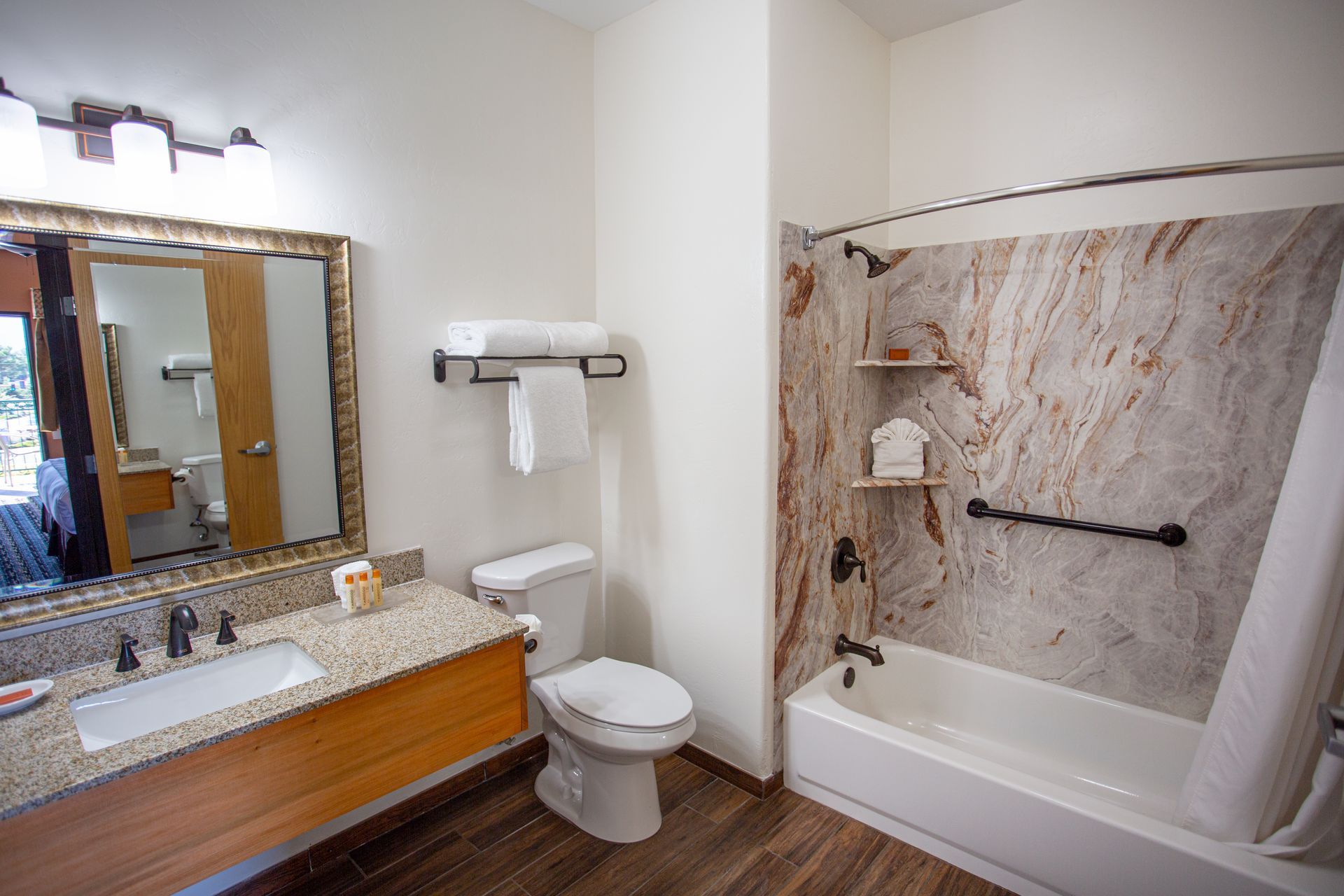 A bathroom with a toilet , sink , and bathtub.