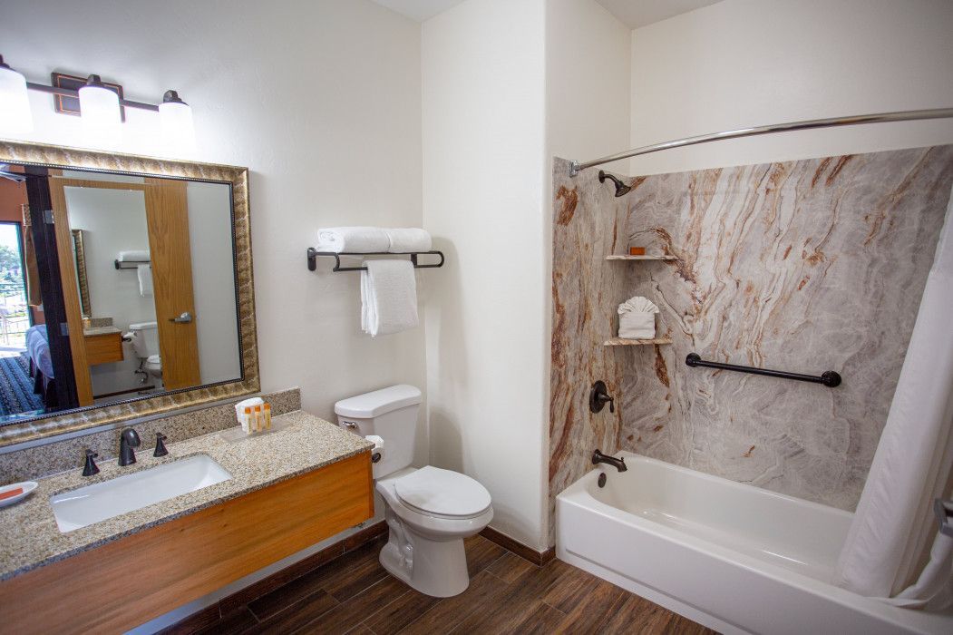 Bathroom at Southwest Inn Sedona equipped with toilet, sink, and bathtub for guest comfort