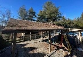 A wooden roof is being built on top of a wooden structure.