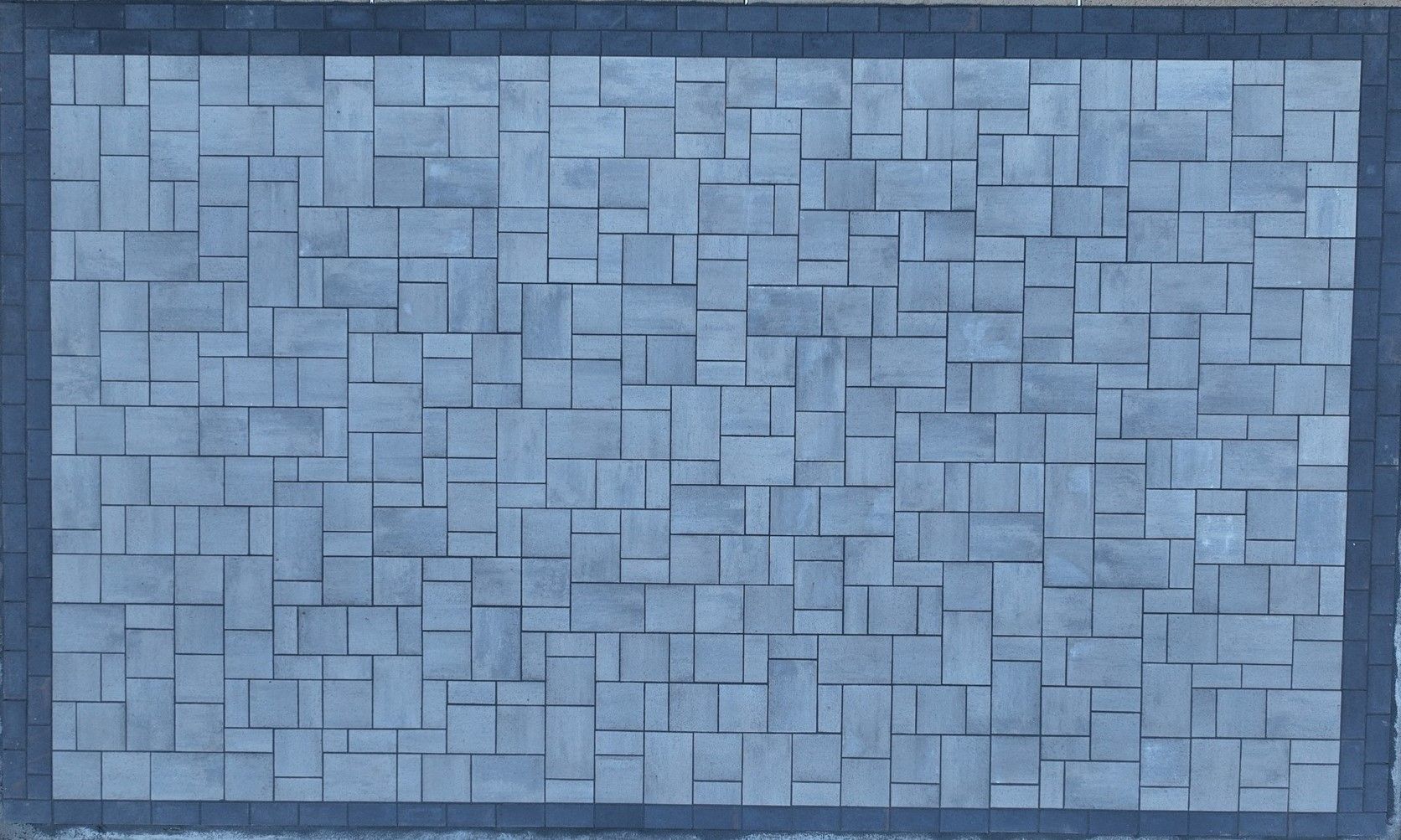 A gray brick wall with a black border