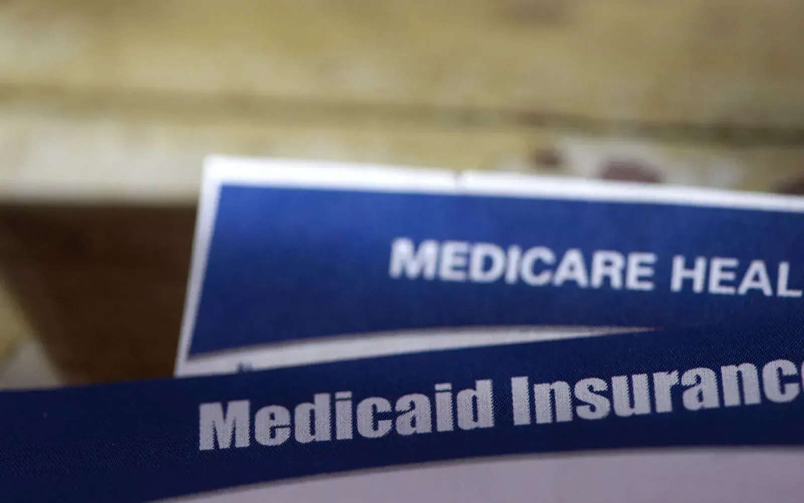 Two pieces of paper that say medicare health and medicaid insurance