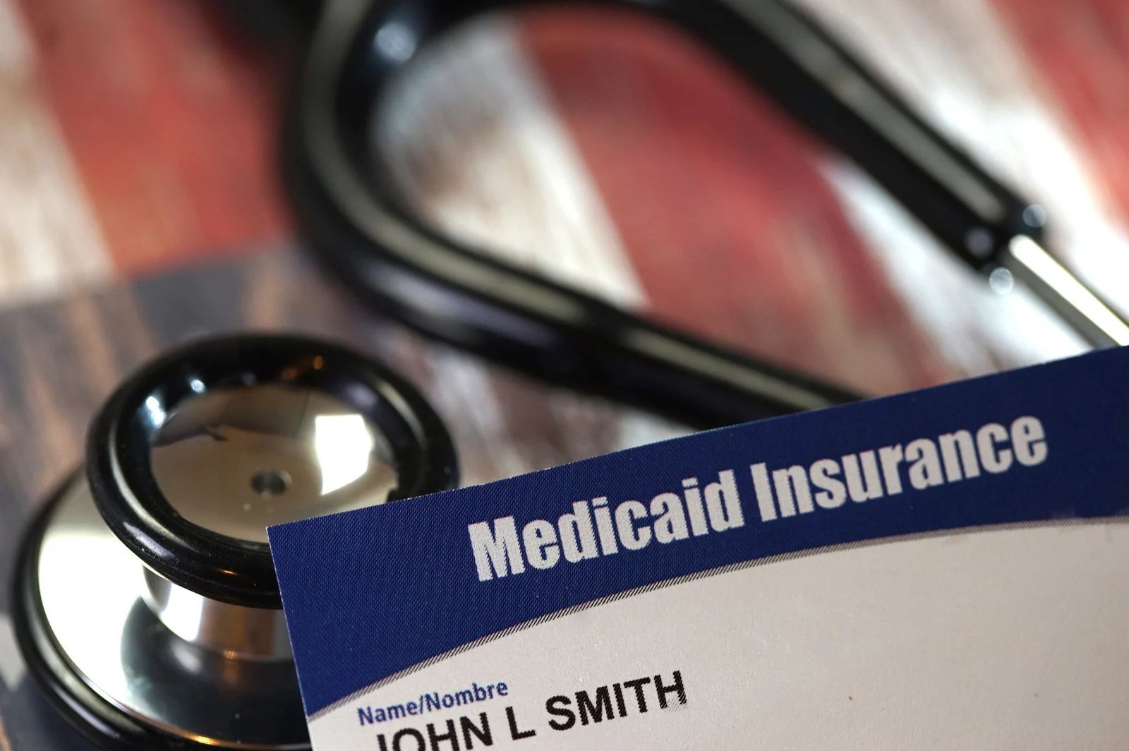 Stethoscope and Medicaid insurance card with name 