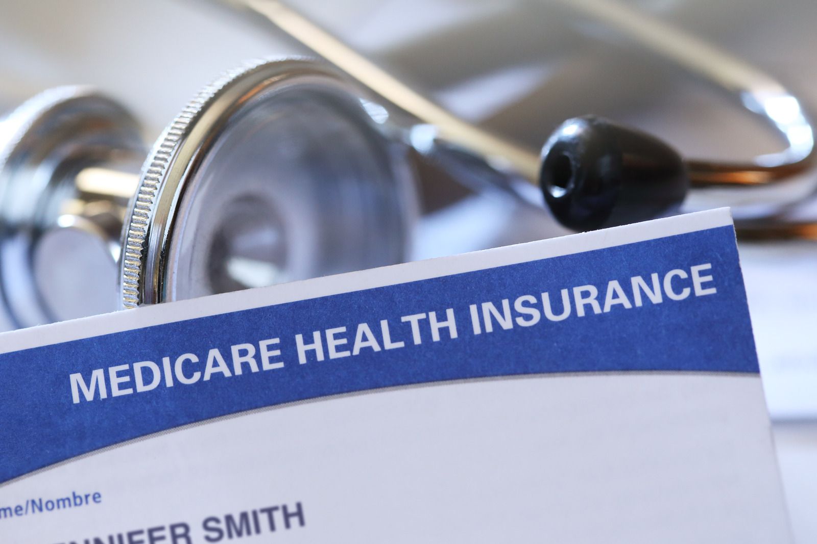 Medicare health insurance card with stethoscope in background.