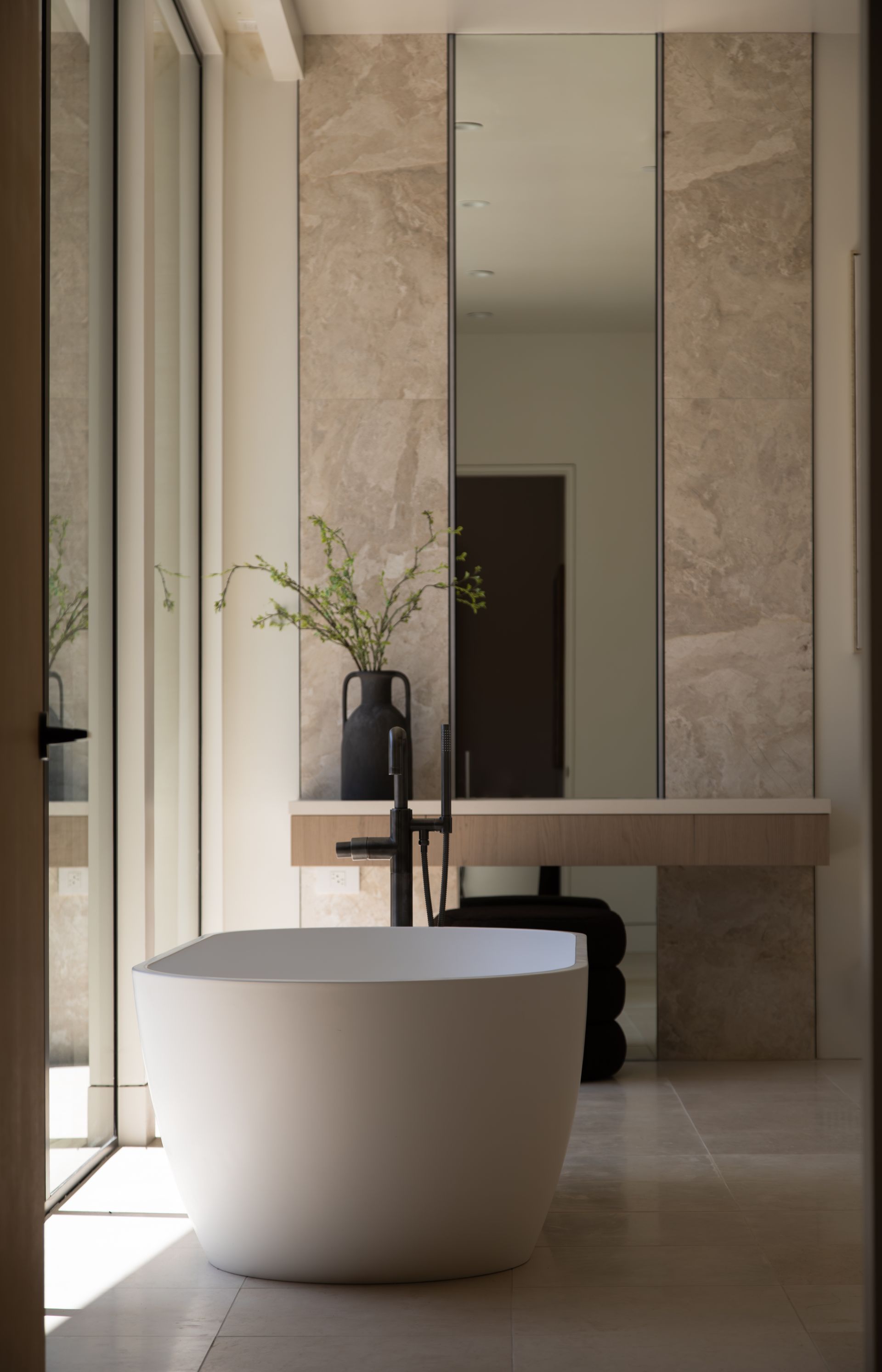 A bathroom with a bathtub , sink and mirror.