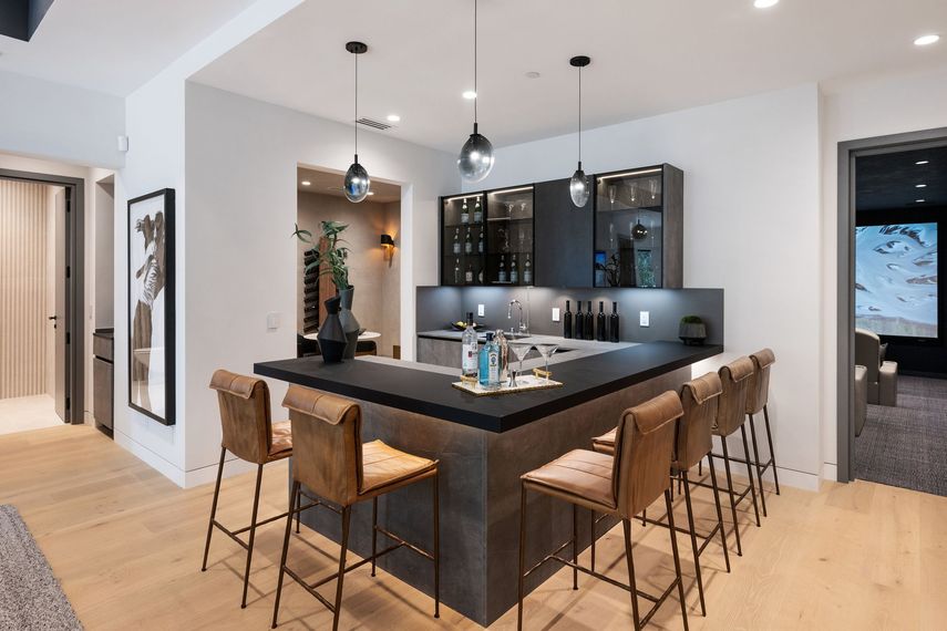 A kitchen with a bar and stools in it
