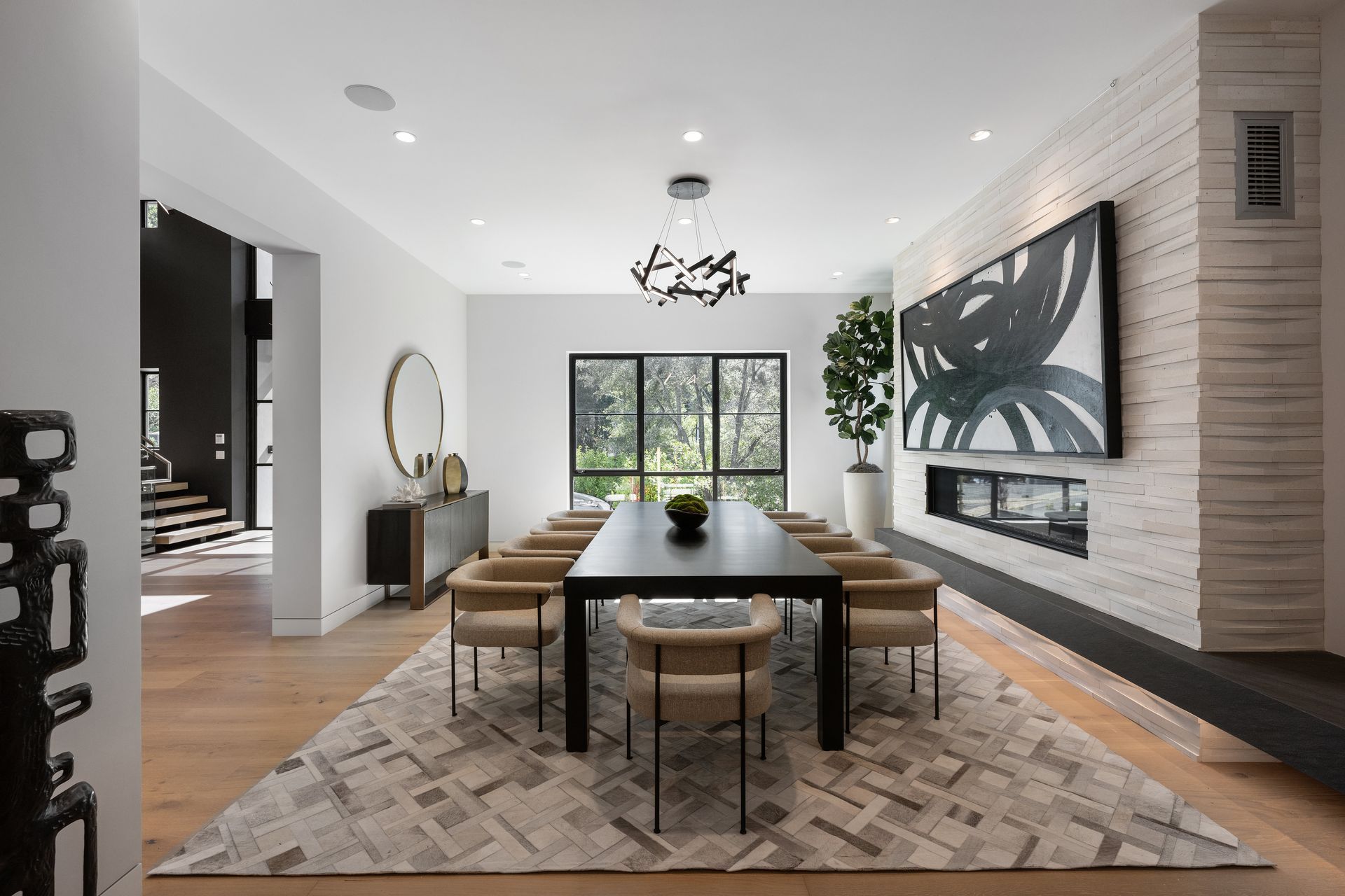 A large dining room with a long table and chairs.