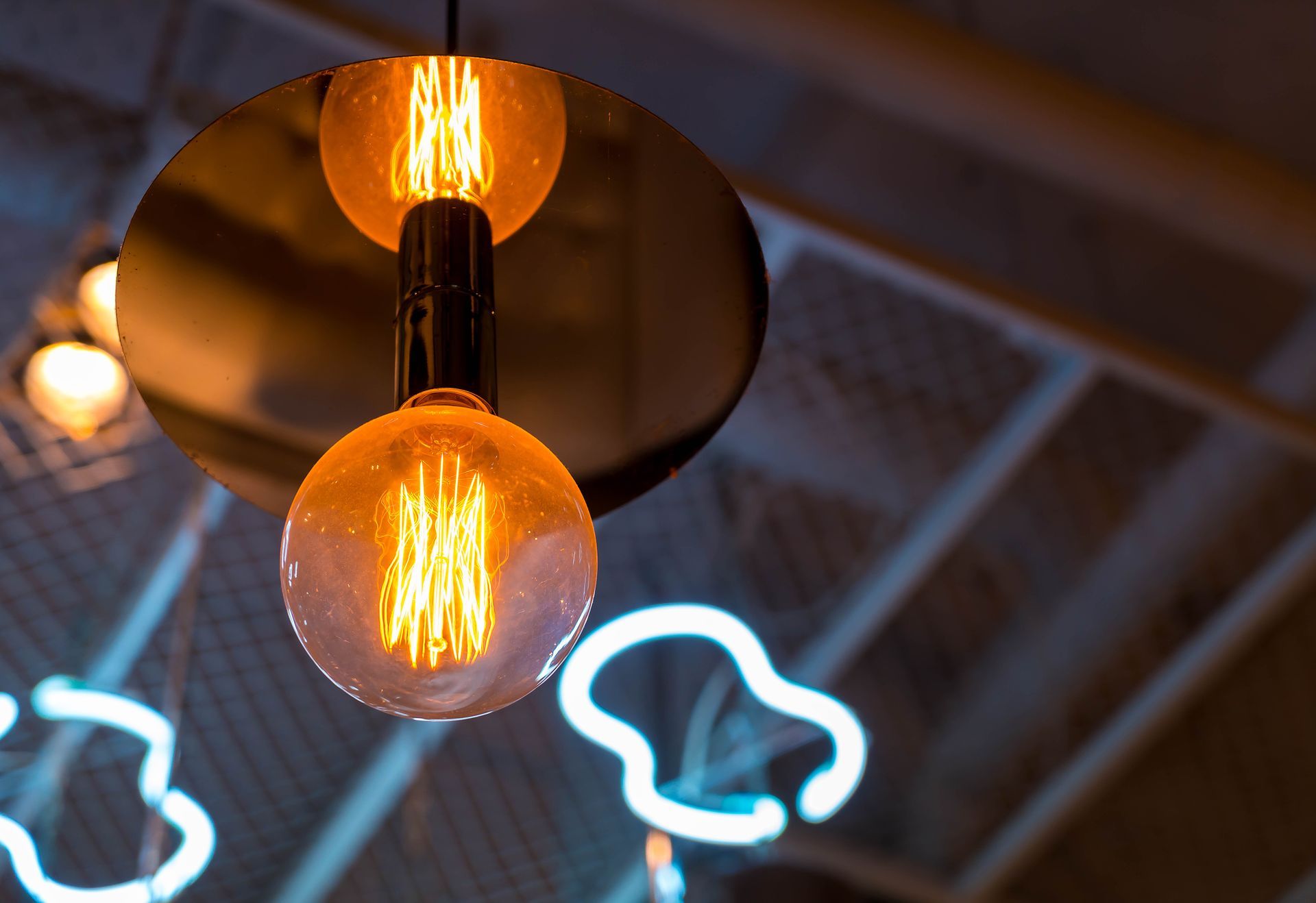 A close up of a light bulb hanging from the ceiling