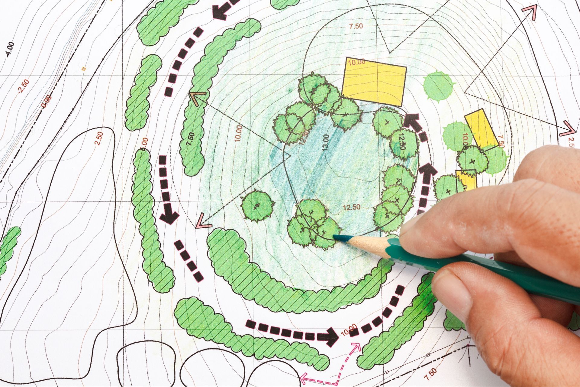 A person is drawing a map with a pencil