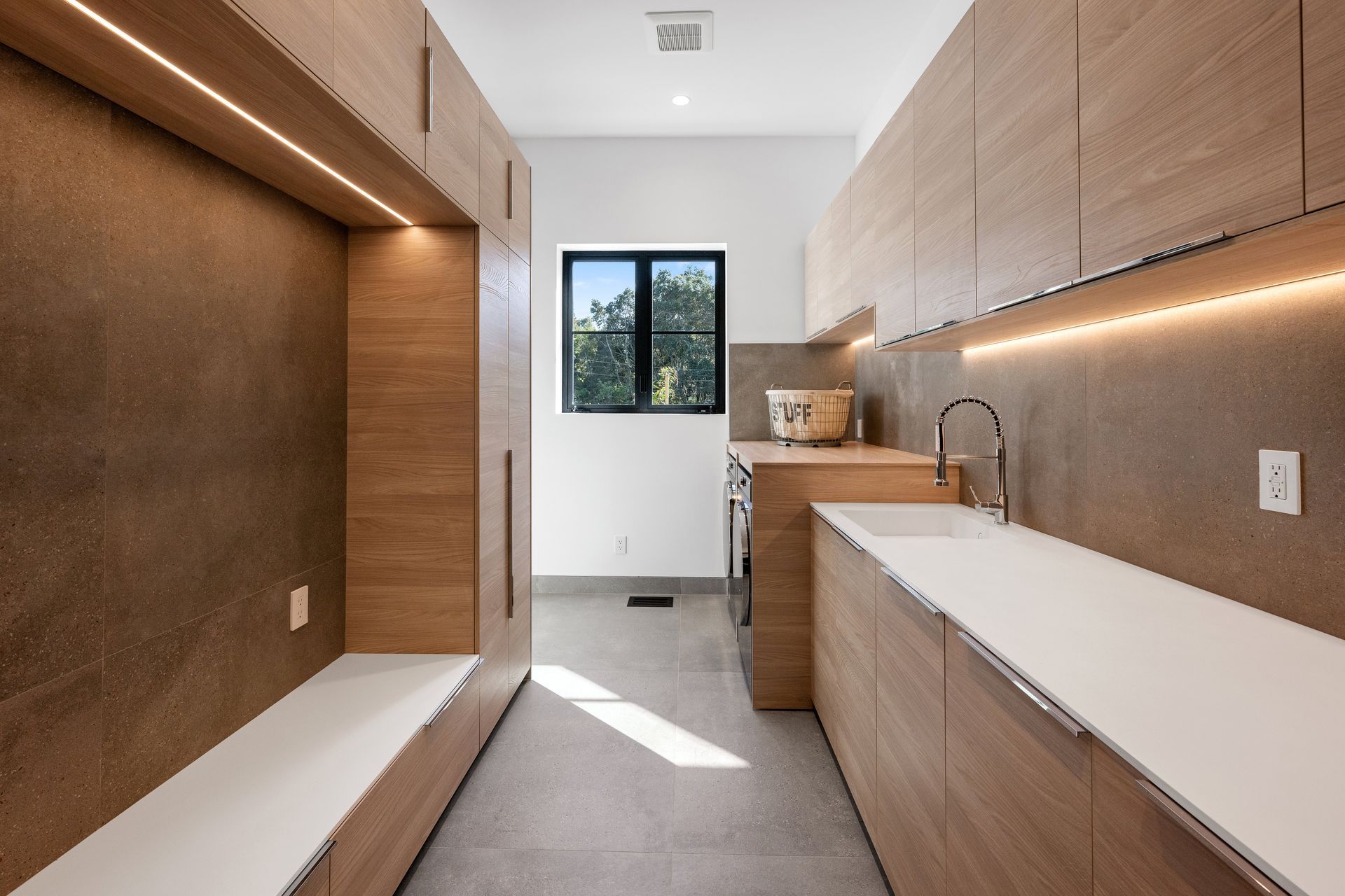 A kitchen with wooden cabinets and white counter tops