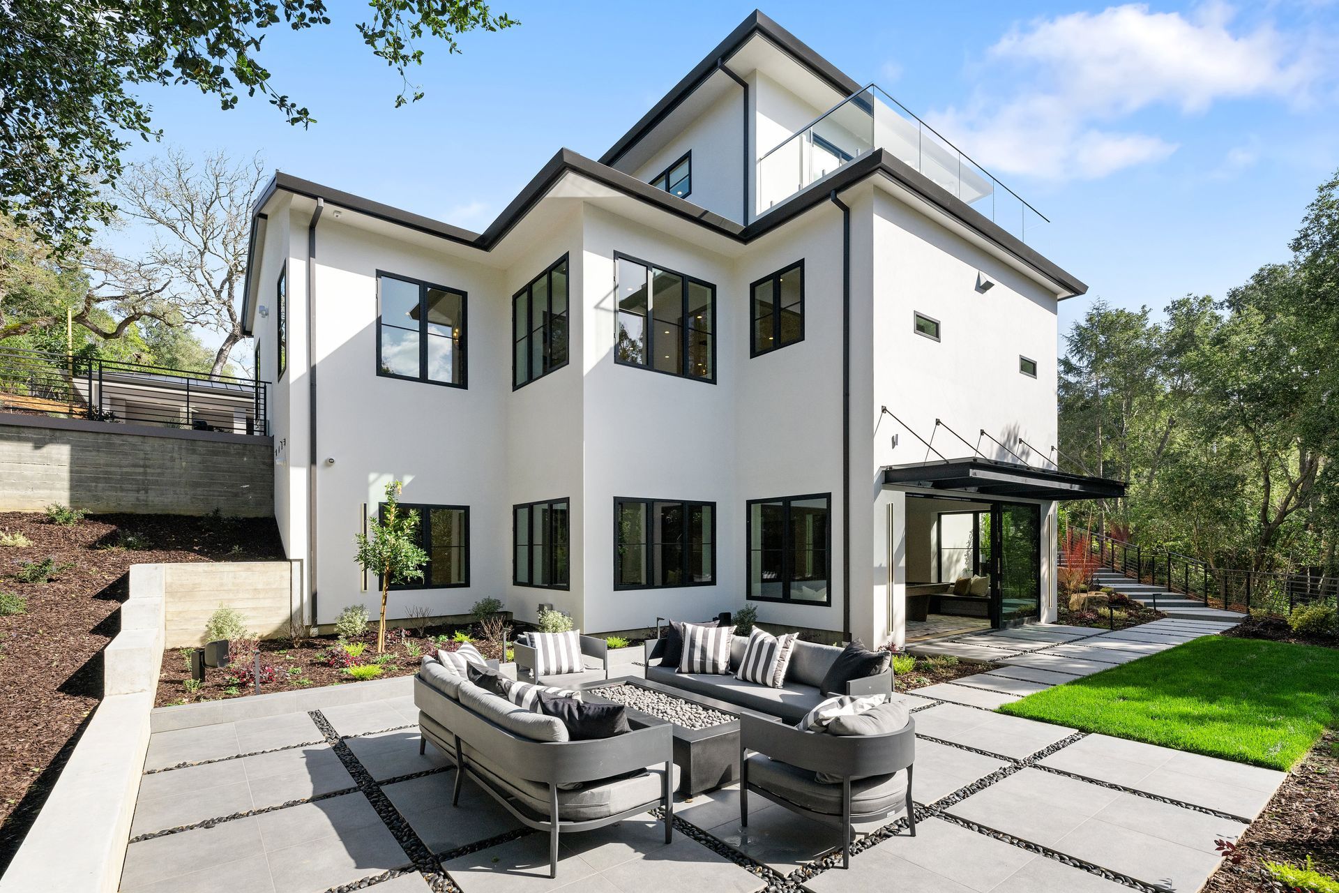 A large white house with a patio area in front of it