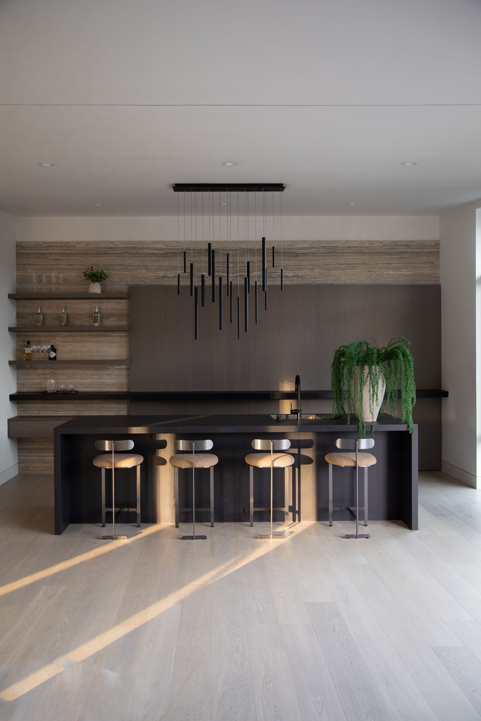 A kitchen with a large island and stools