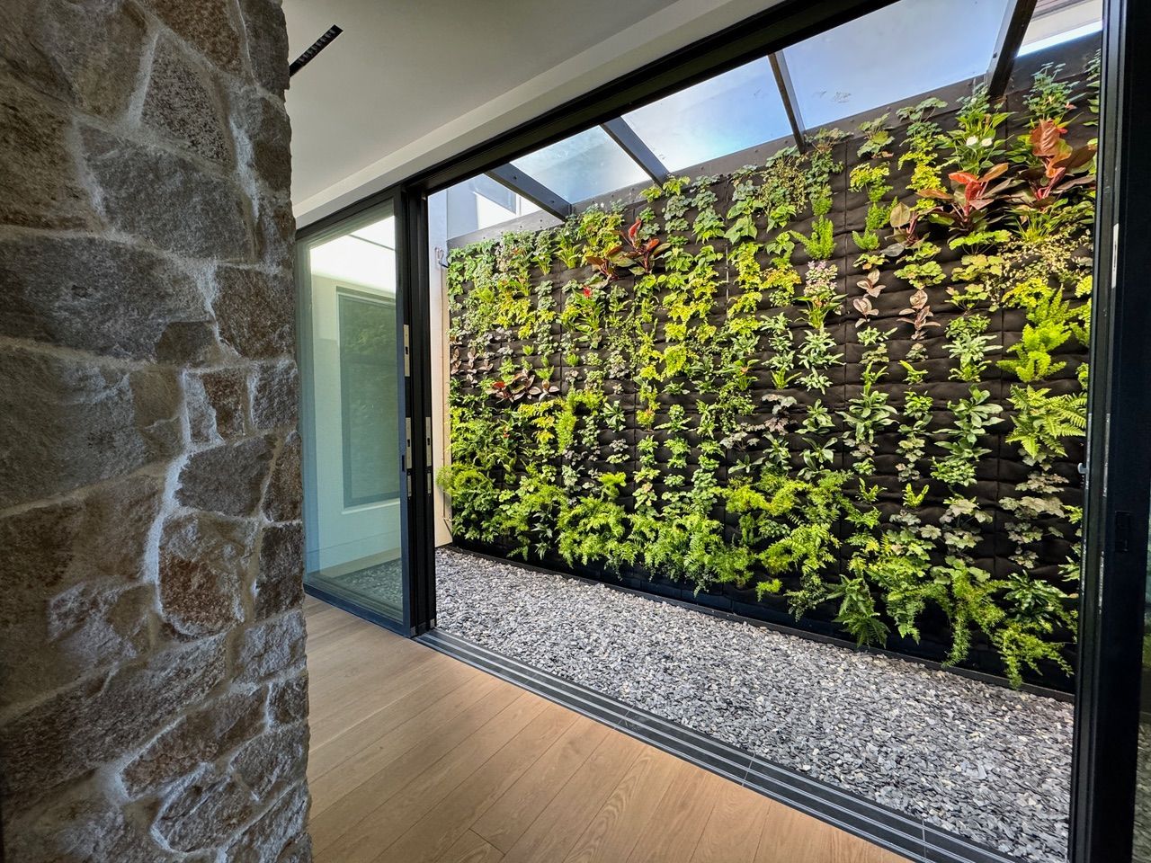 A stone wall with a green wall behind it