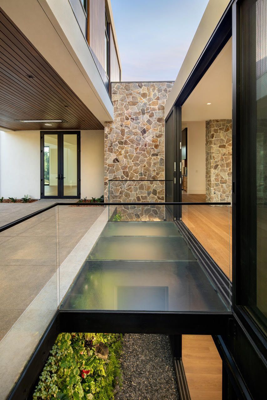 A house with a glass walkway between two buildings