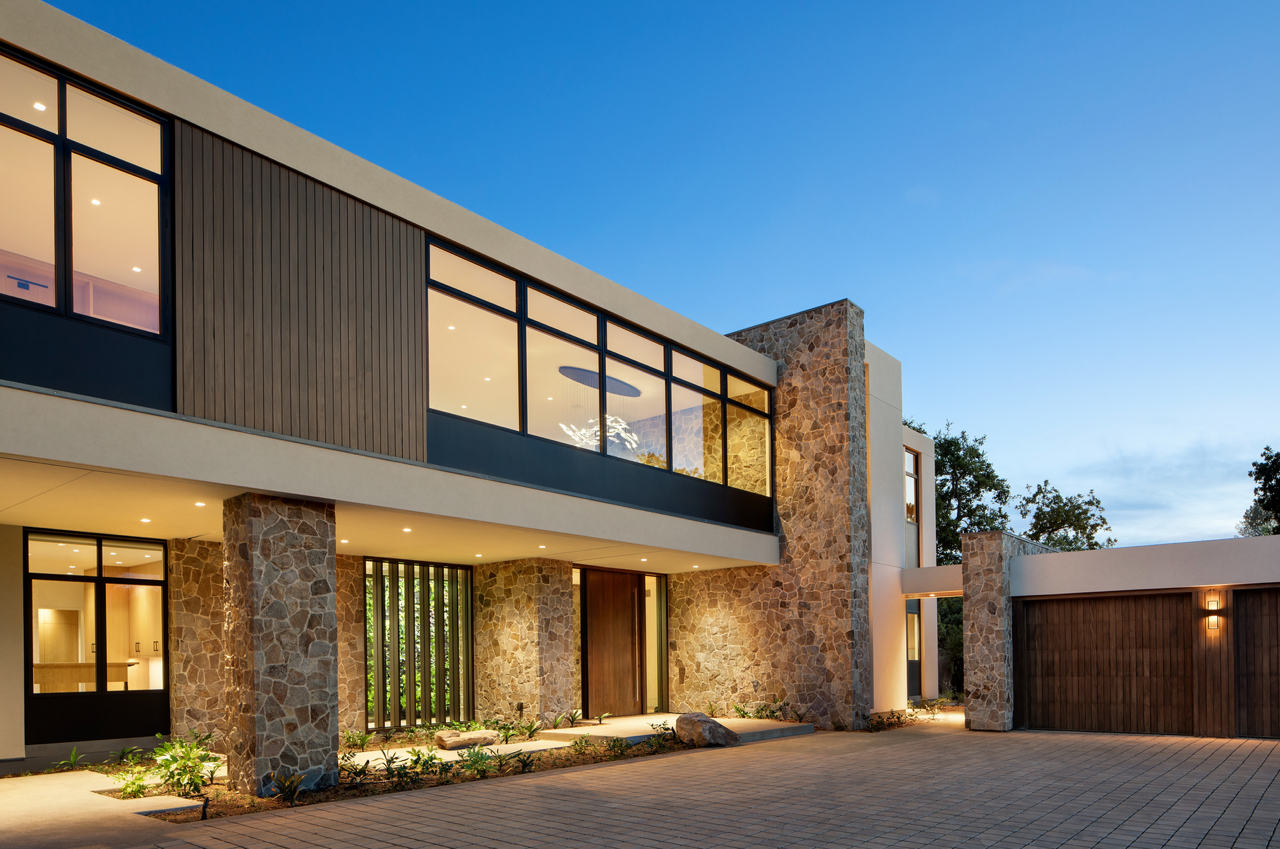 A large house with a lot of windows and a garage