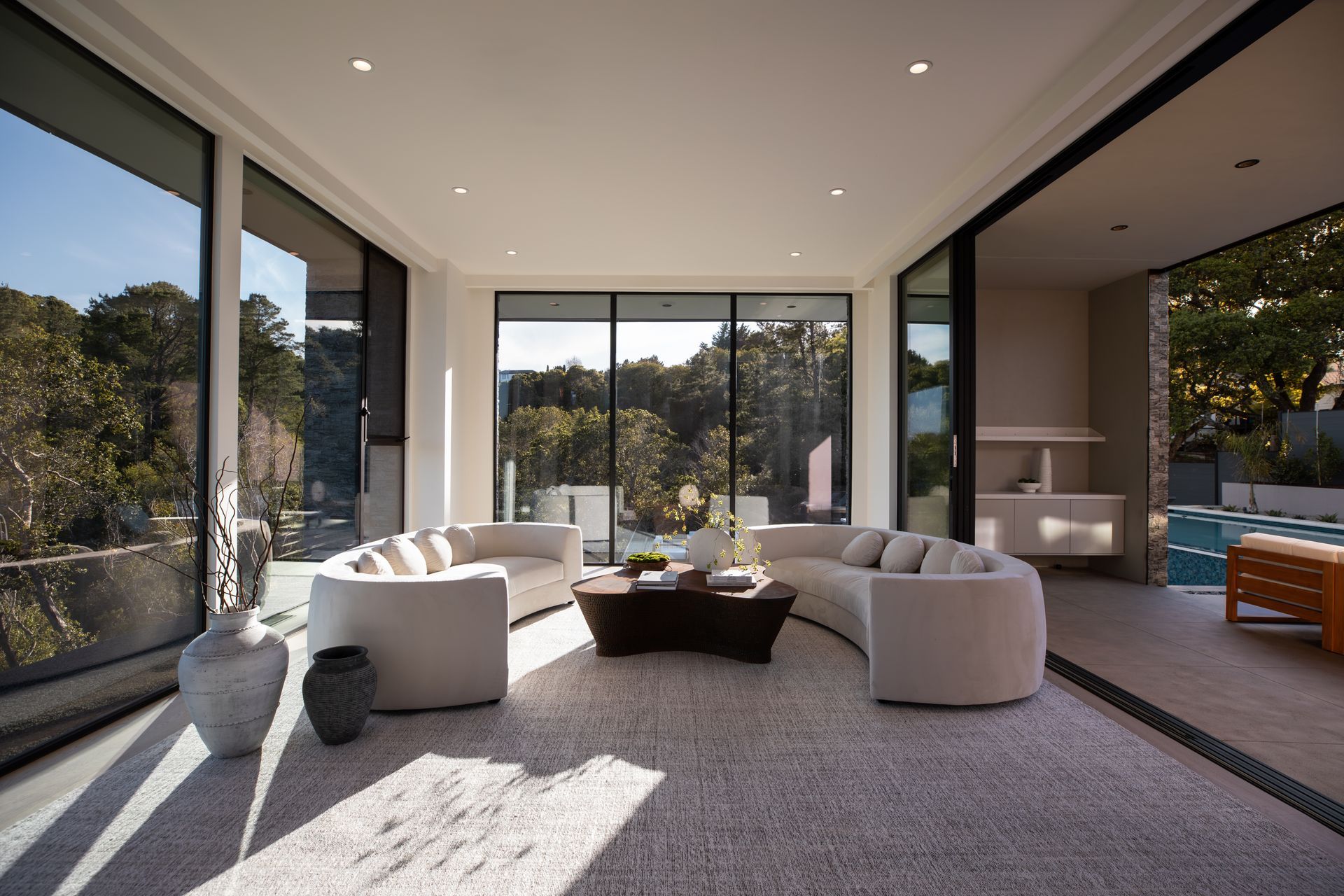A living room with a lot of windows and furniture
