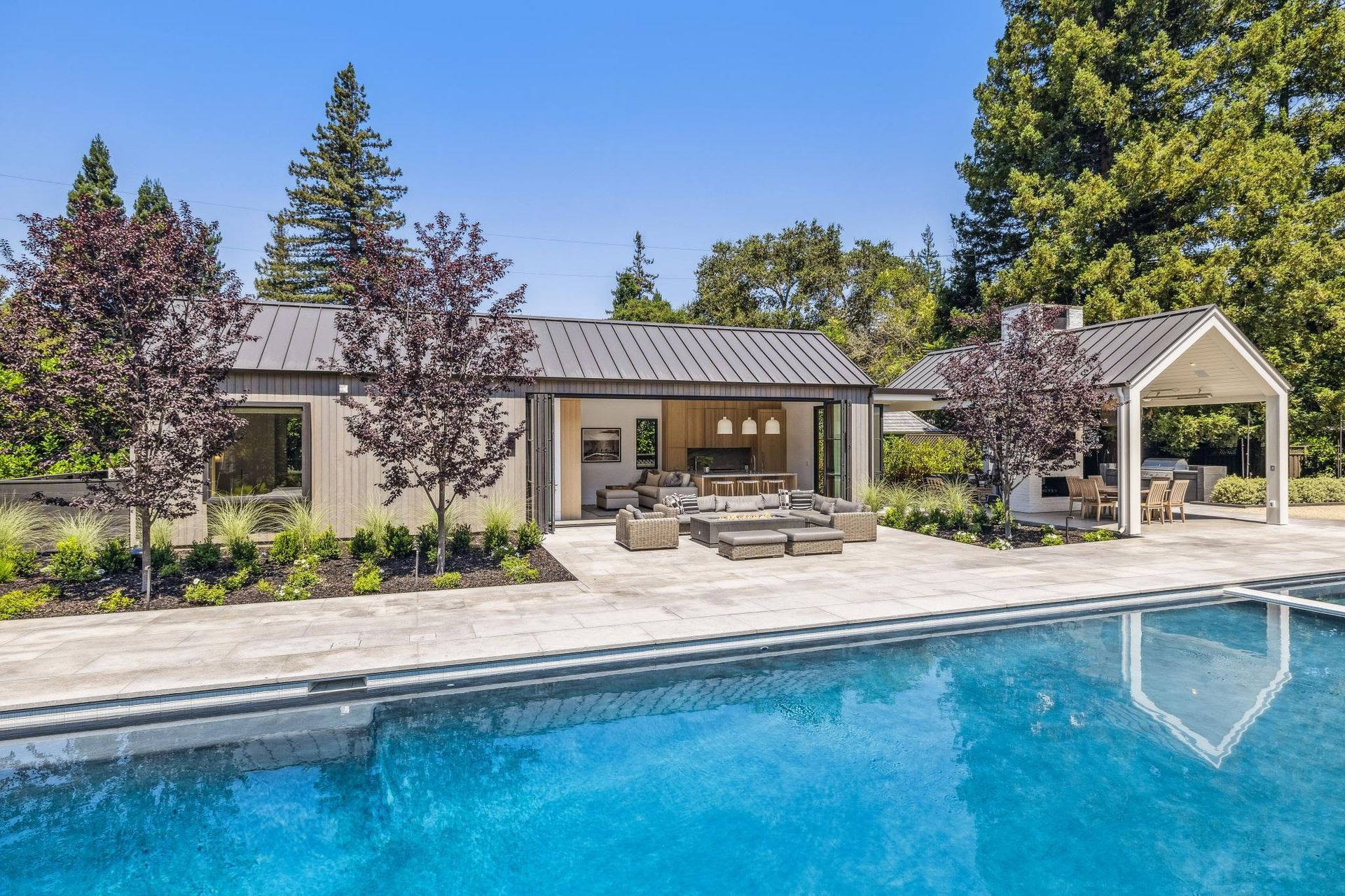 A house with a swimming pool in front of it