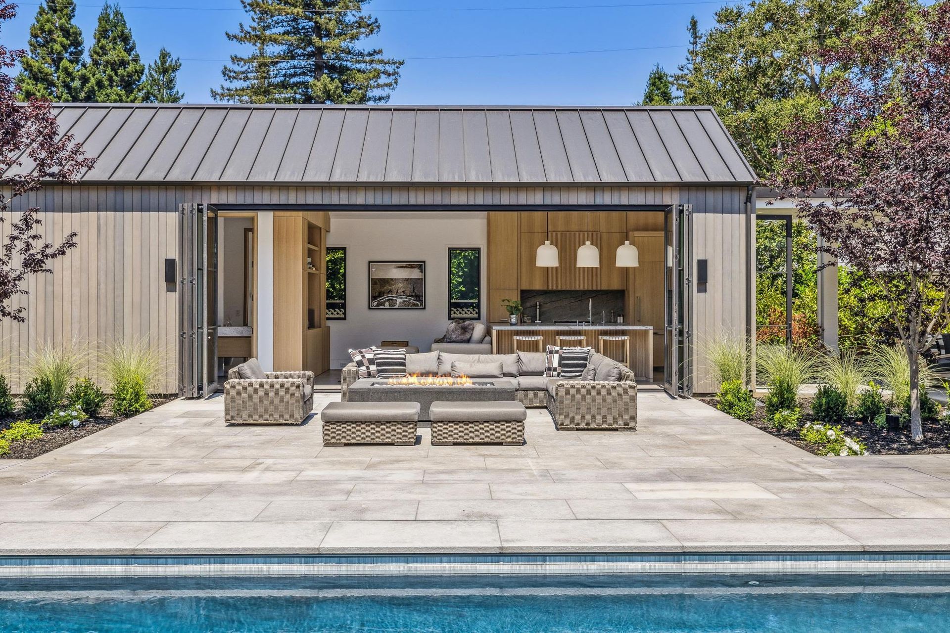 A large house with a swimming pool in front of it.