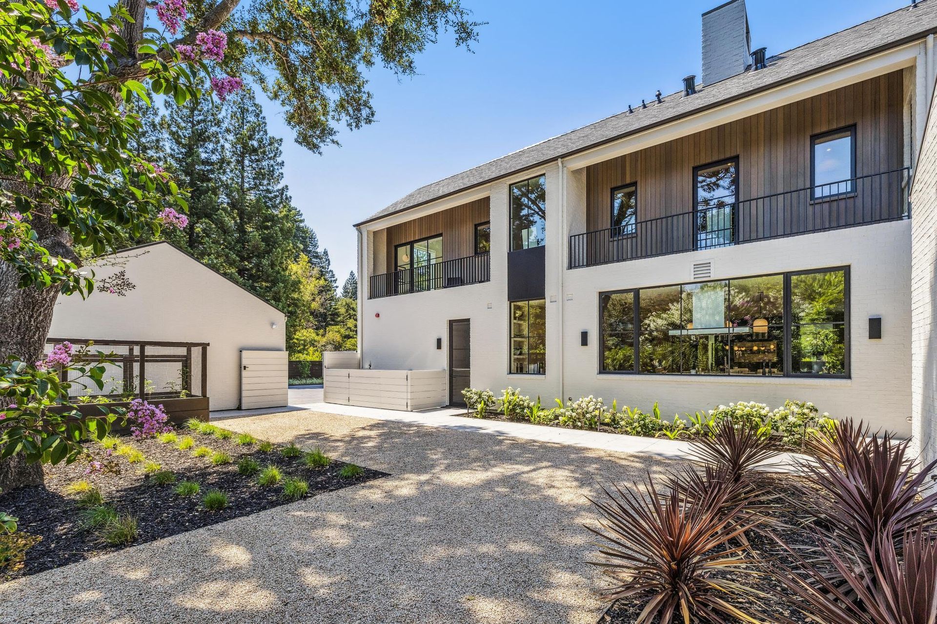 A large white house with a lot of windows and a garage.