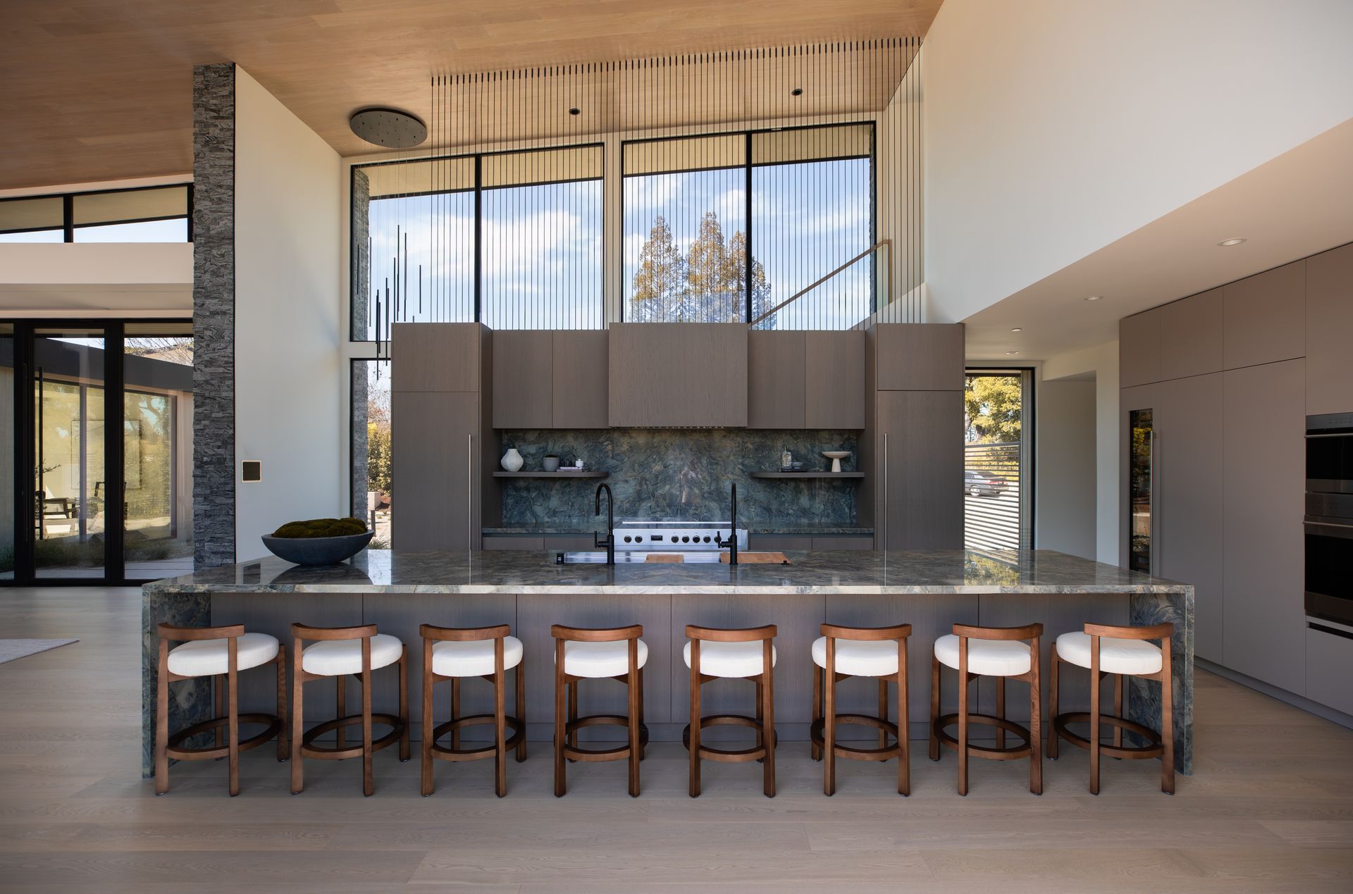 A kitchen with a large island and stools