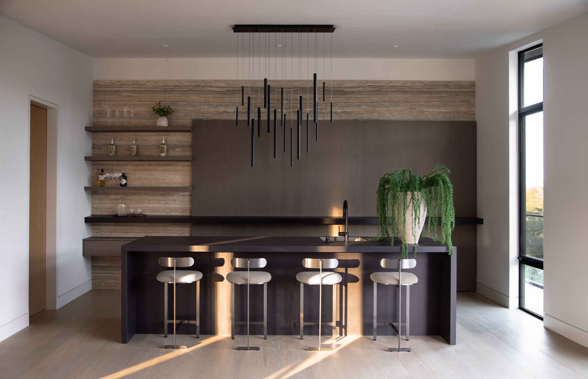 A kitchen with a large island and stools
