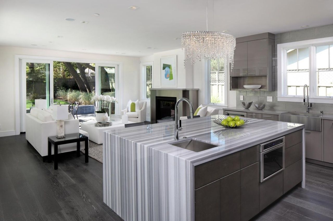 A kitchen with a large island in the middle of the room.