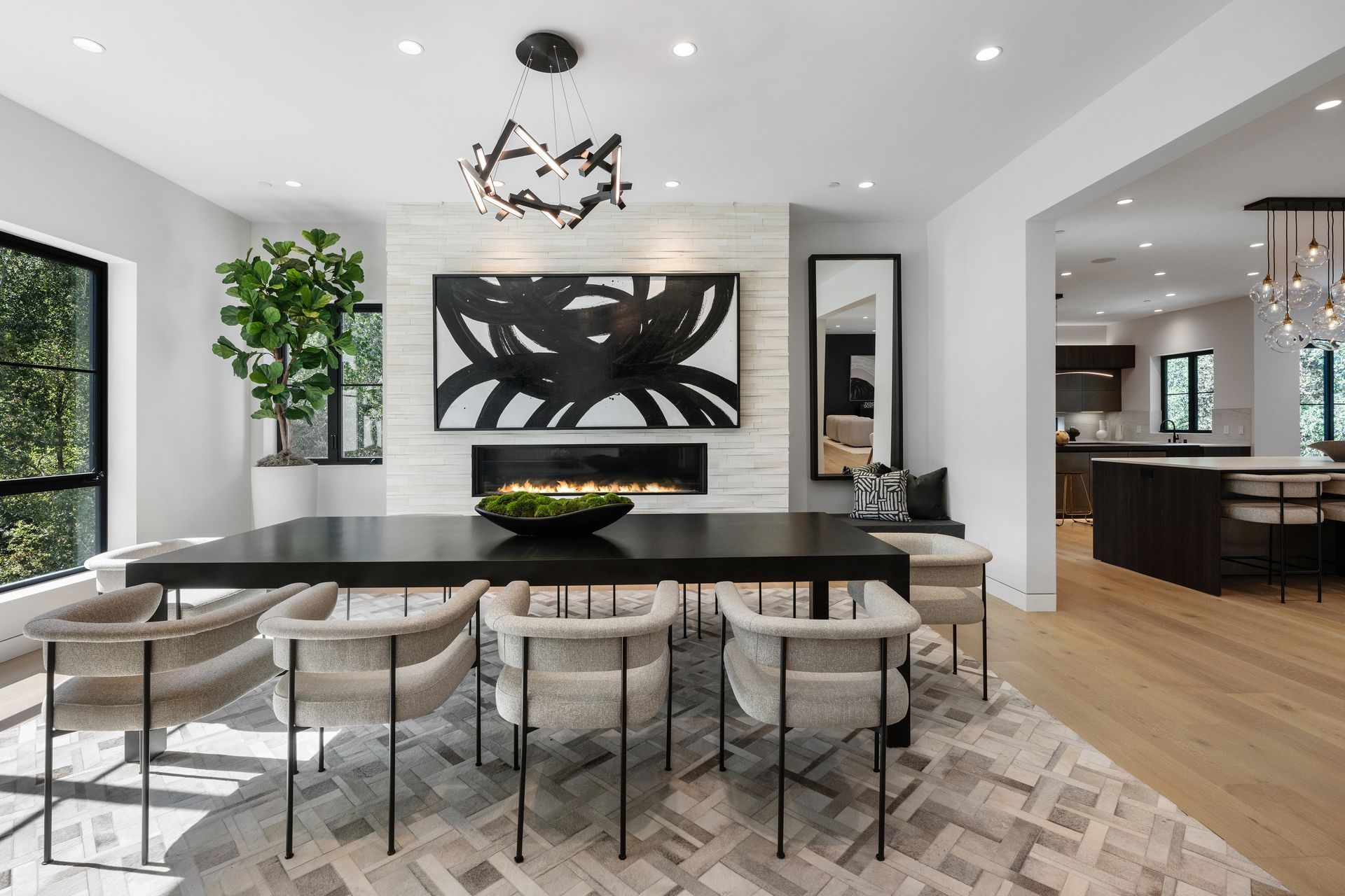 A dining room with a table and chairs and a fireplace.