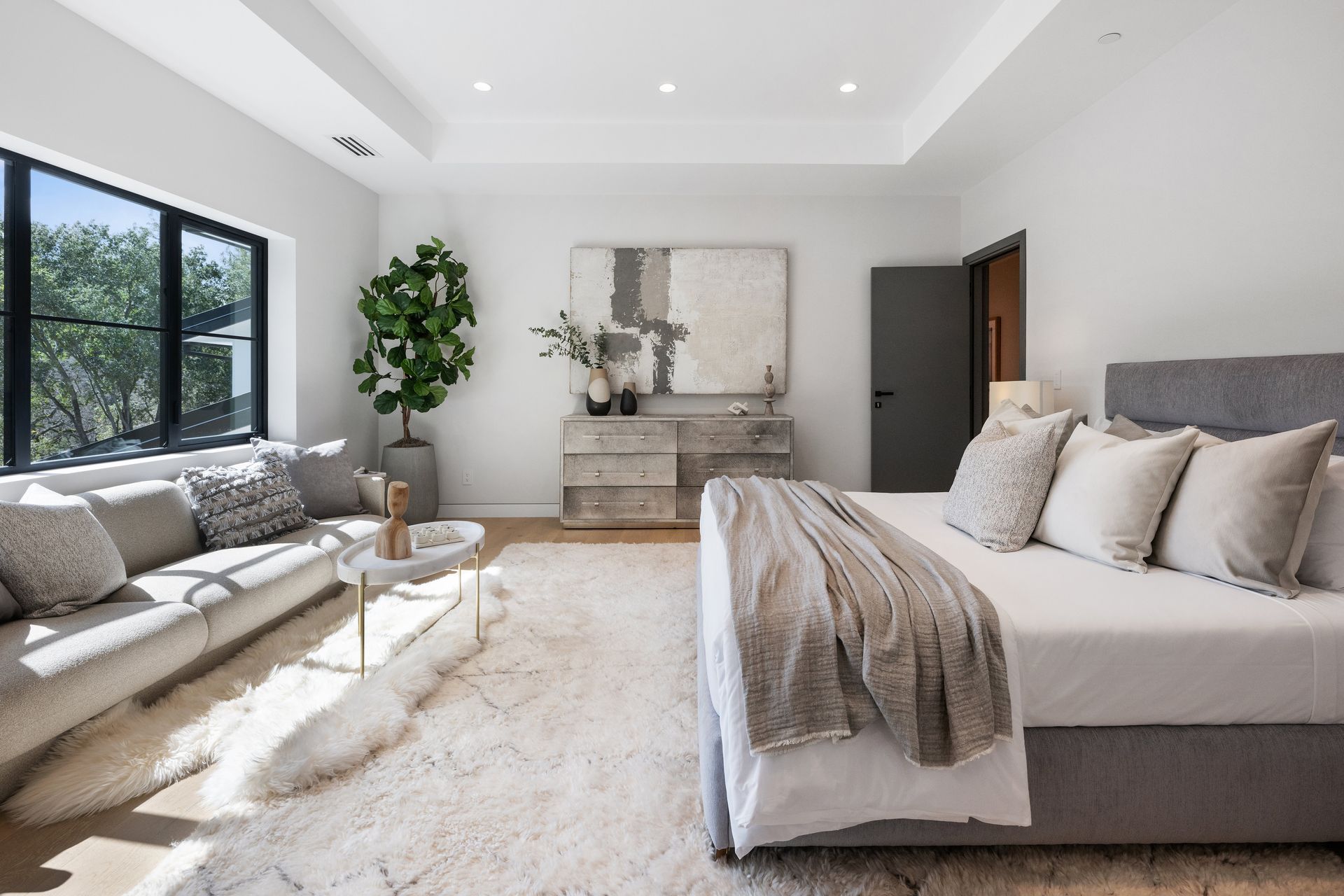 A bedroom with a large bed and a couch.