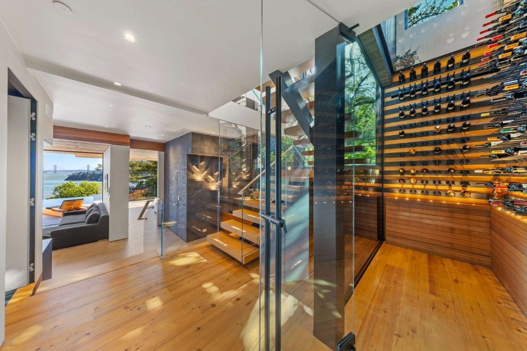 A modern house with a staircase and a wine cellar.