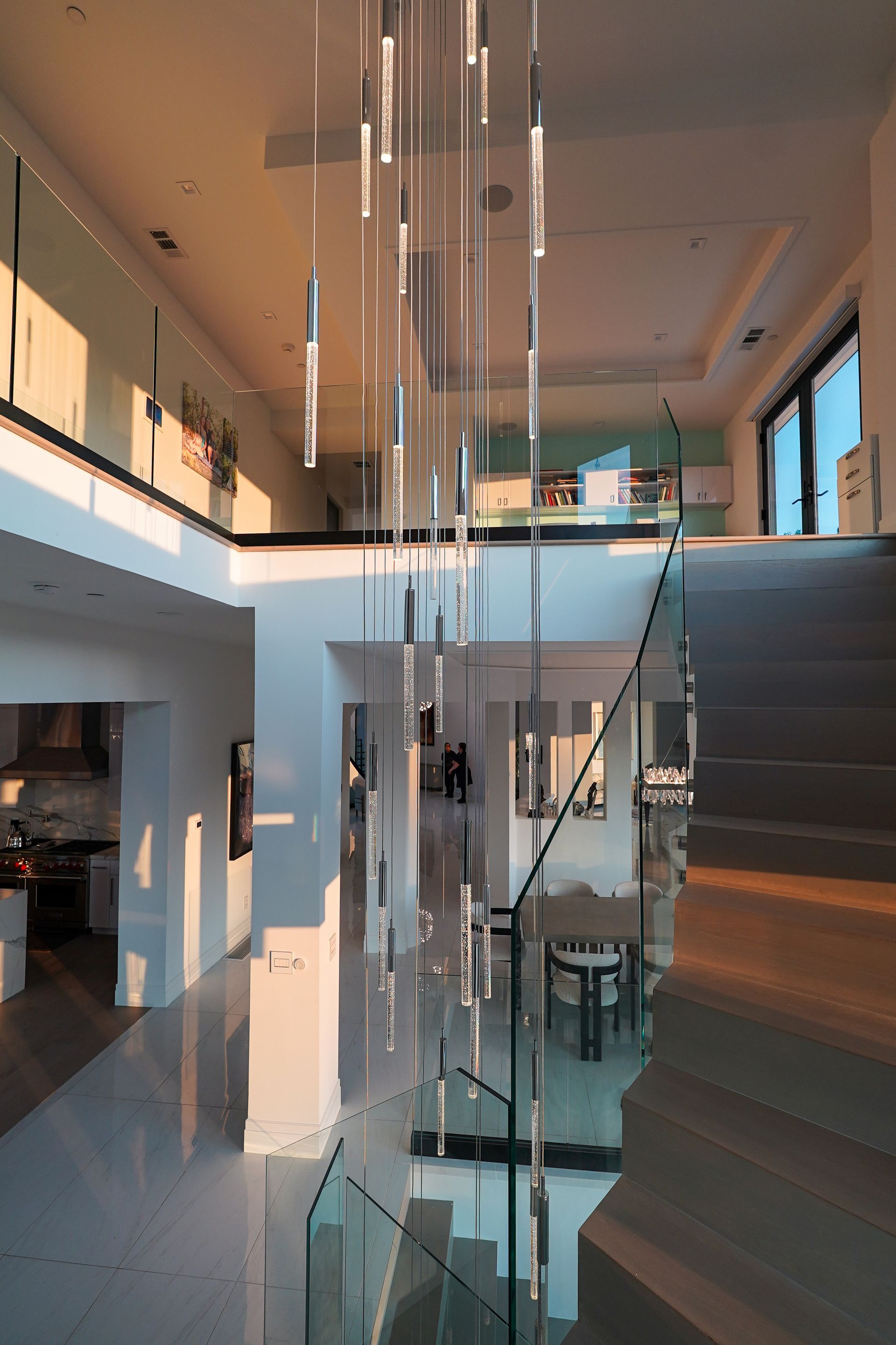 A staircase in a house with a glass railing